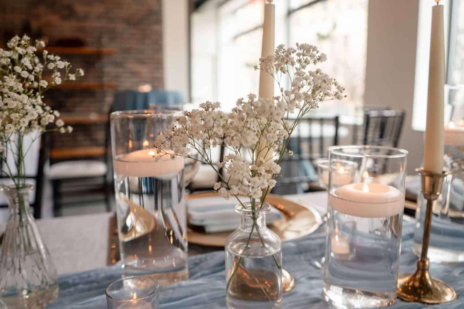 Beautiful table setup with candles, flowers, and elegant tableware for events.