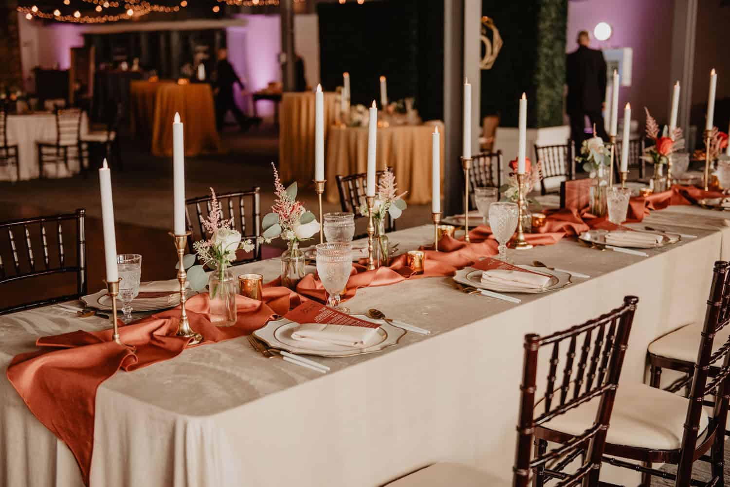 Beautifully decorated event table with candles and floral arrangements at SKY Armory.