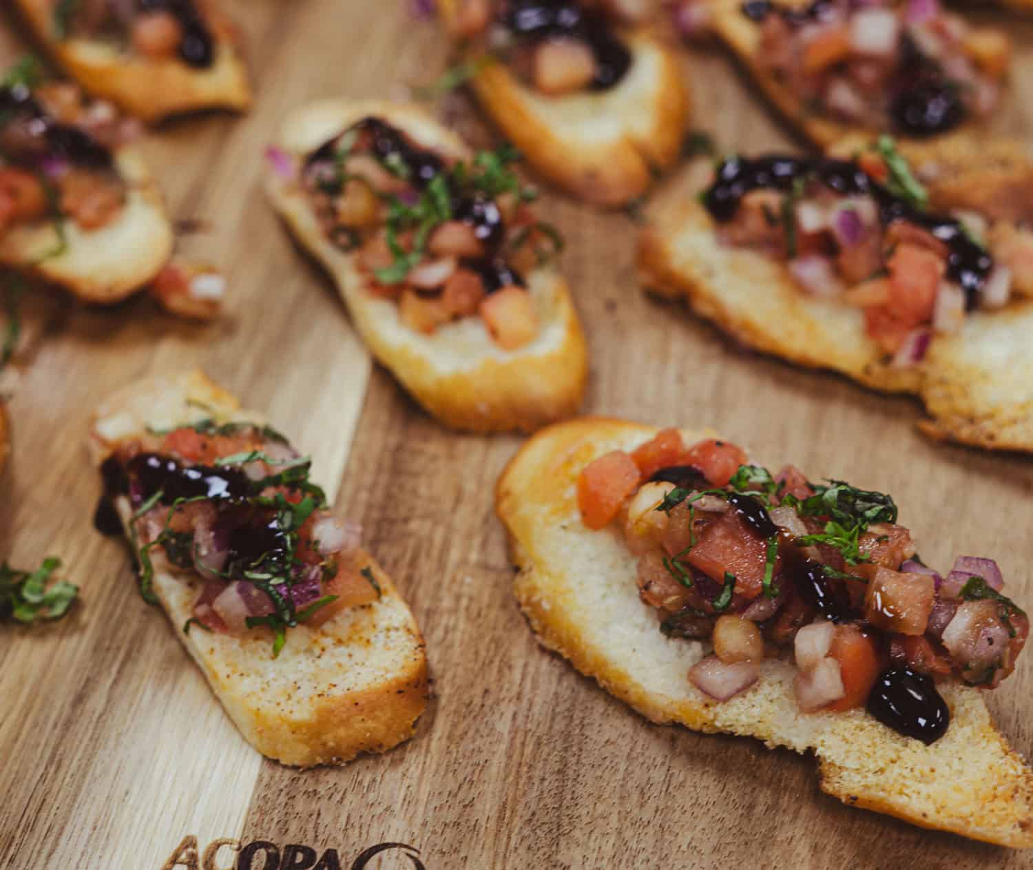 SKY Armory Gourmet Appetizers Delicious gourmet appetizers with toppings on toasted bread slices.