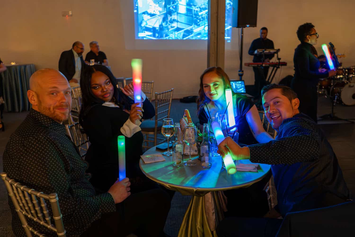 Group of people enjoying a celebration with glow sticks at SKY Armory.