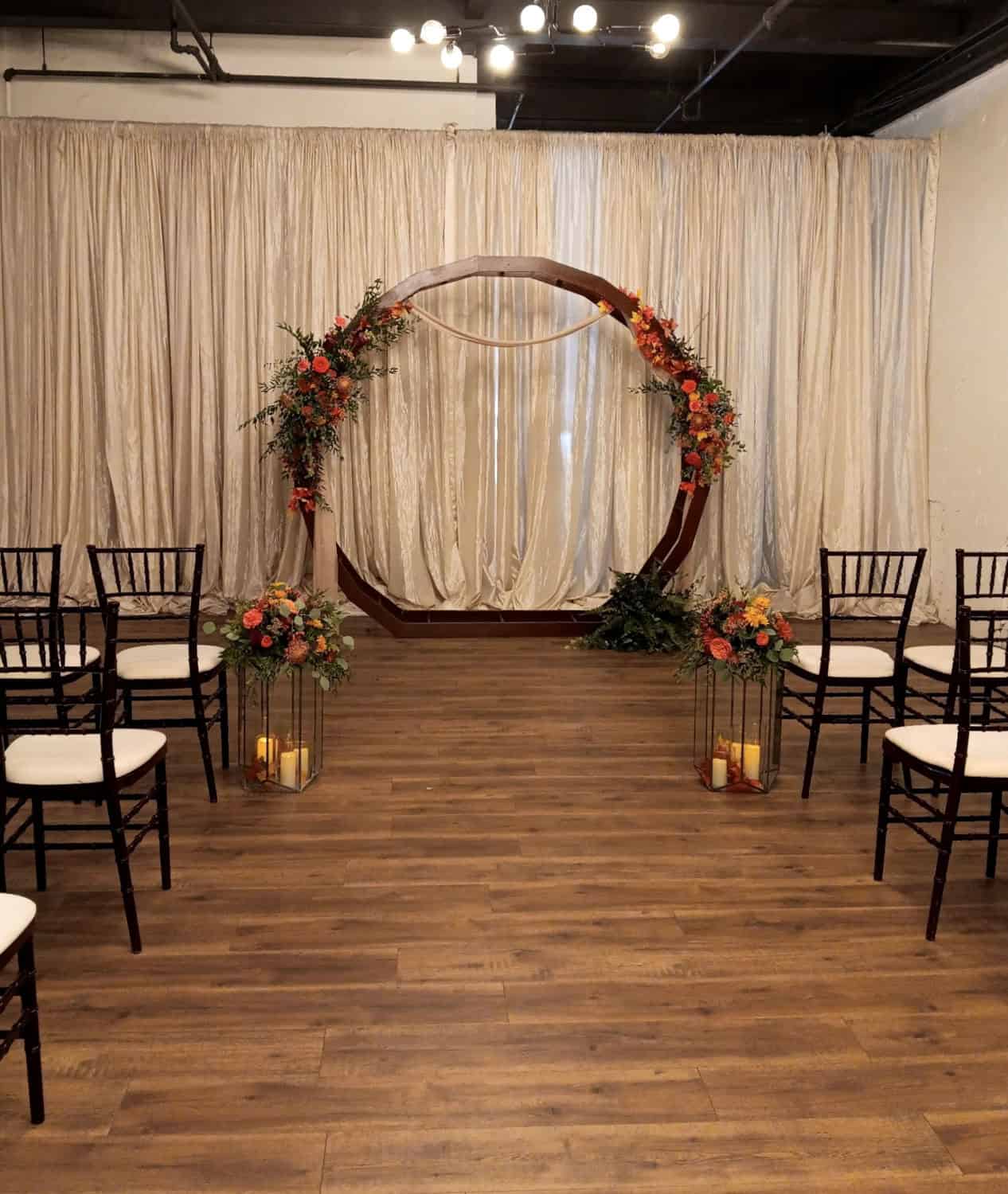 Wedding ceremony arch decorated with flowers at SKY Armory venue.