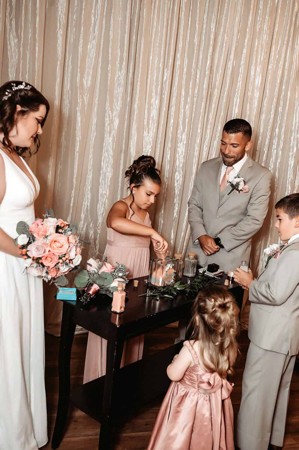 Wedding scene with children and adults in formal attire at SKY Armory.