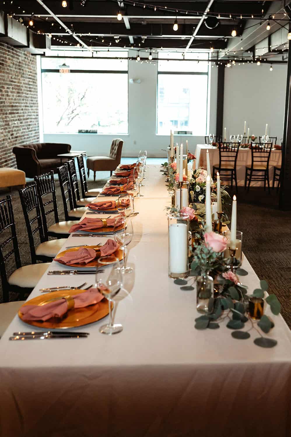 Beautifully decorated event table with candles and floral arrangements at SKY Armory.