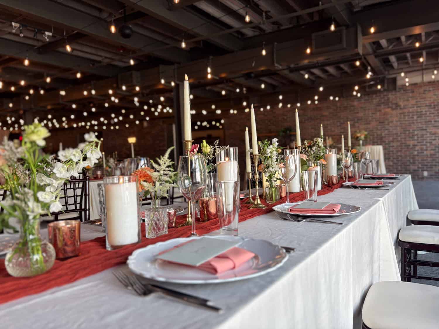 Decorated banquet table with candles and flowers at SKY Armory event venue.