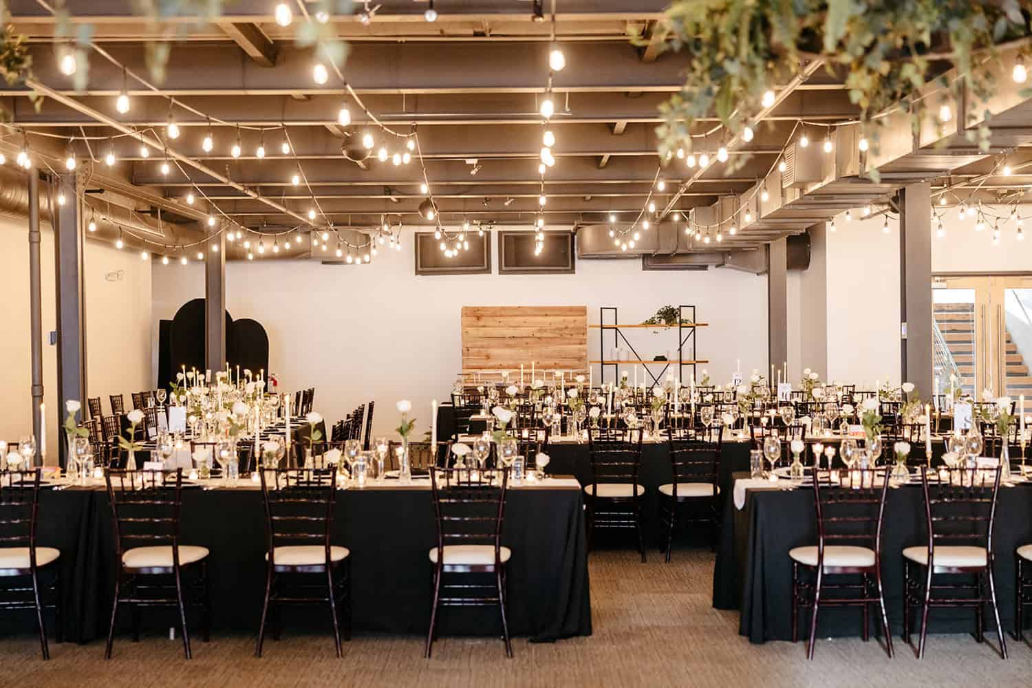 Event space with decorated tables, string lights, and elegant ambiance at SKY Armory.