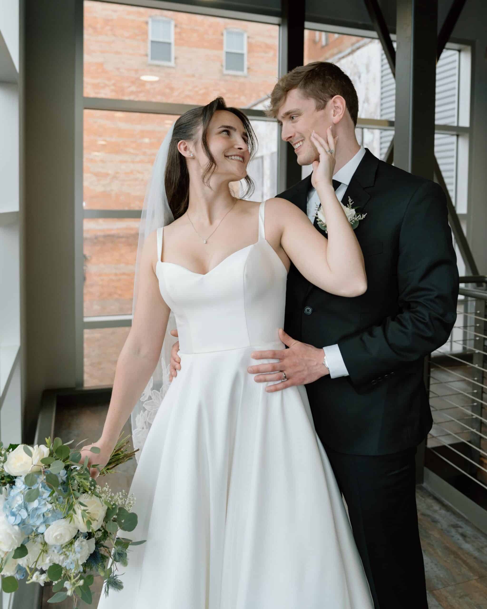 Bride and groom sharing a romantic moment at SKY Armory wedding venue.