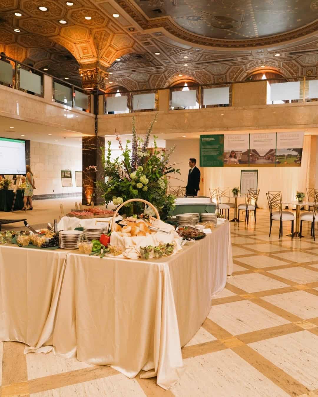 Elegant event setup with floral arrangements and buffet table at SKY Armory.