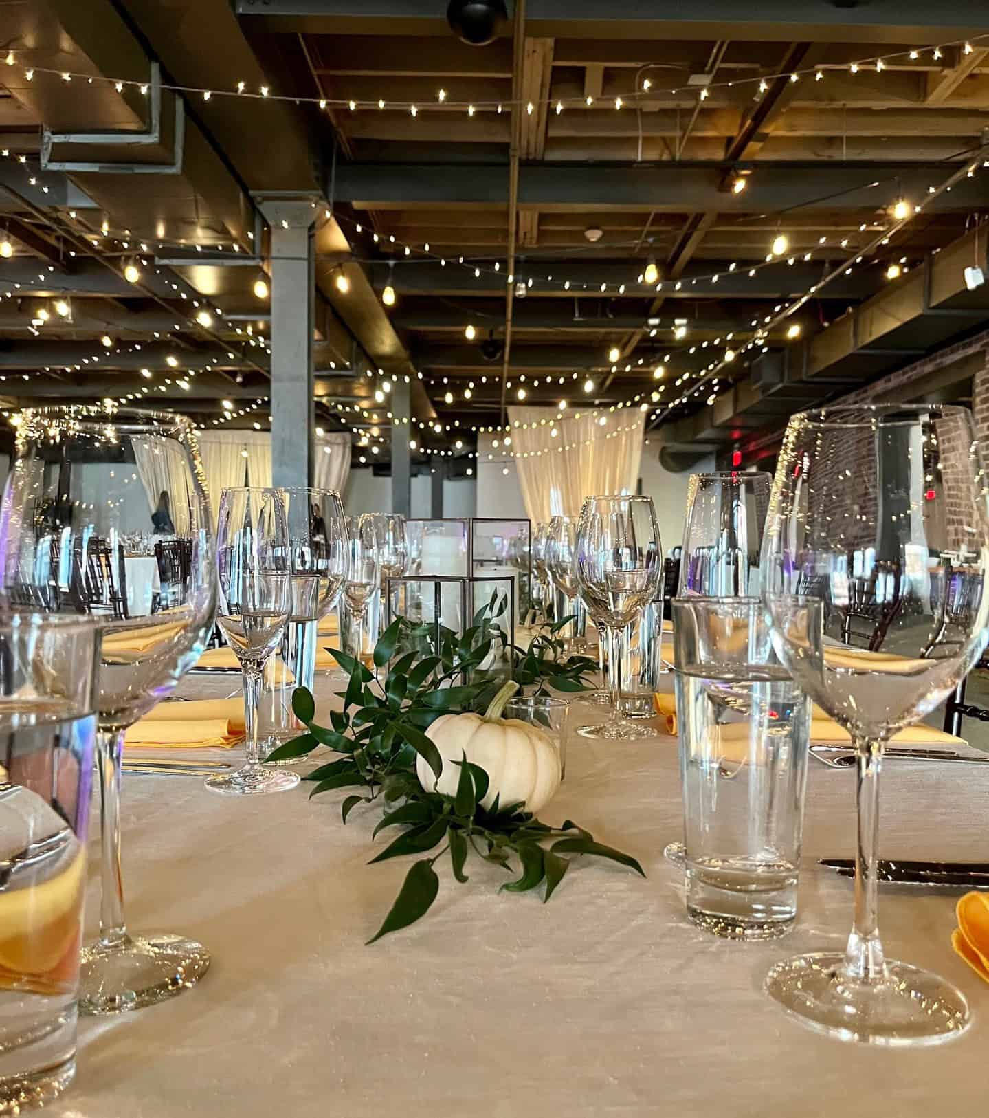 Beautifully arranged event table with glassware and floral centerpiece at SKY Armory.