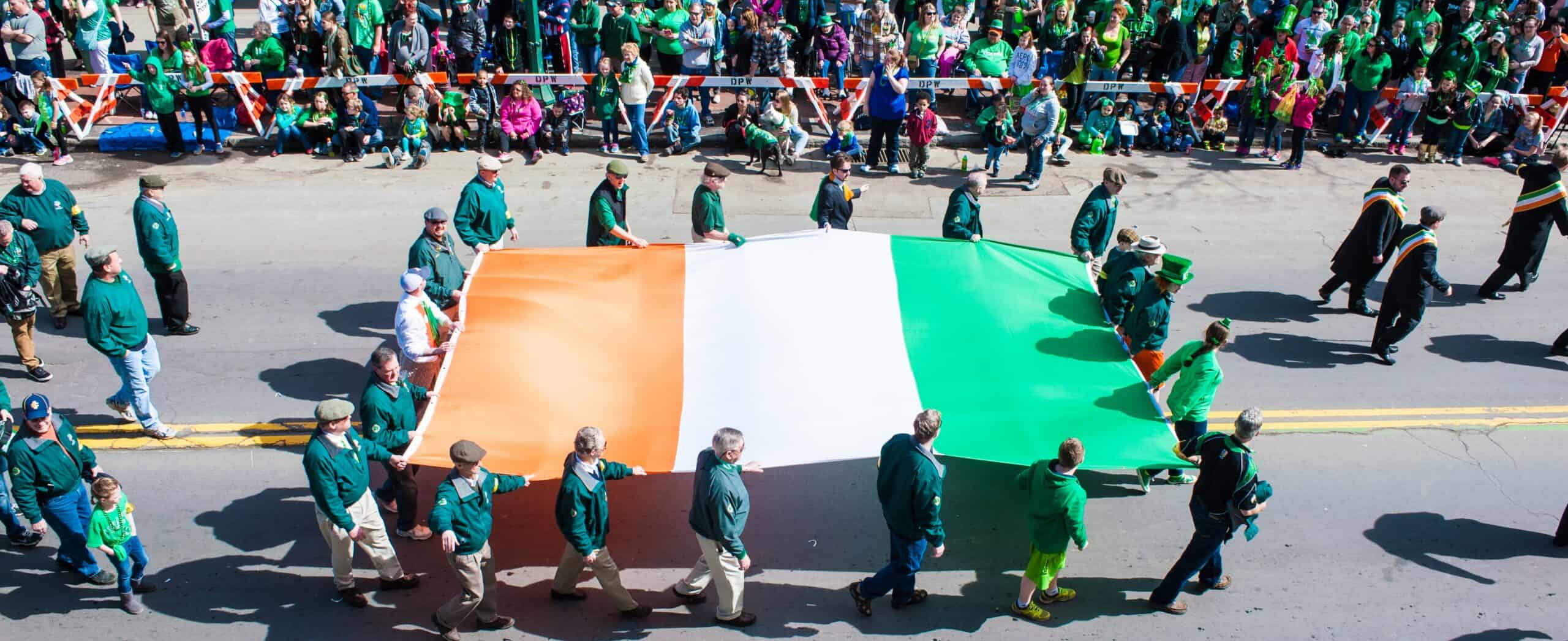 Large Irish flag carried by parade participants during Syracuse St. Patrick’s Day Parade.