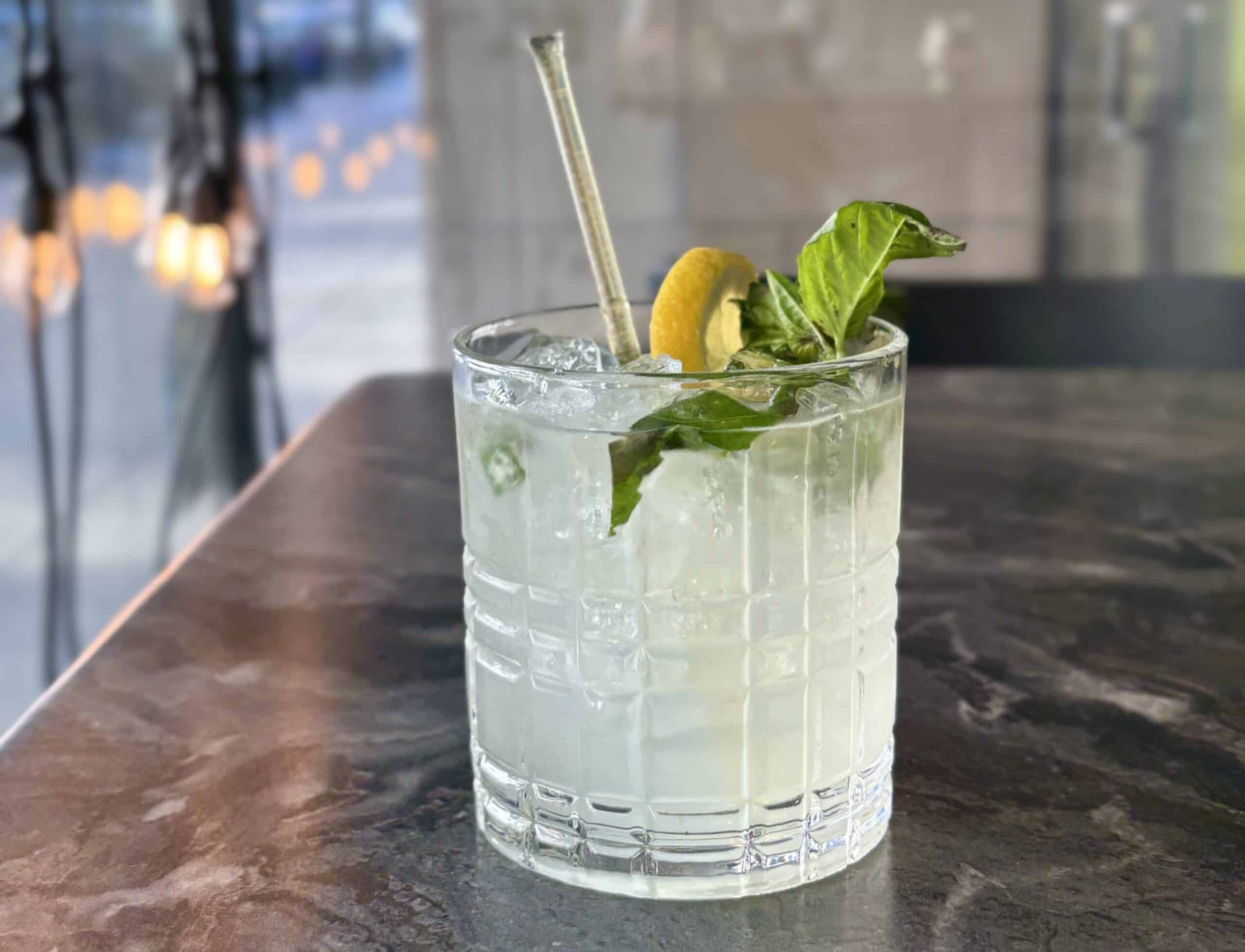 Refreshing cocktail with lemon and basil, perfect for Kentucky Derby celebrations.