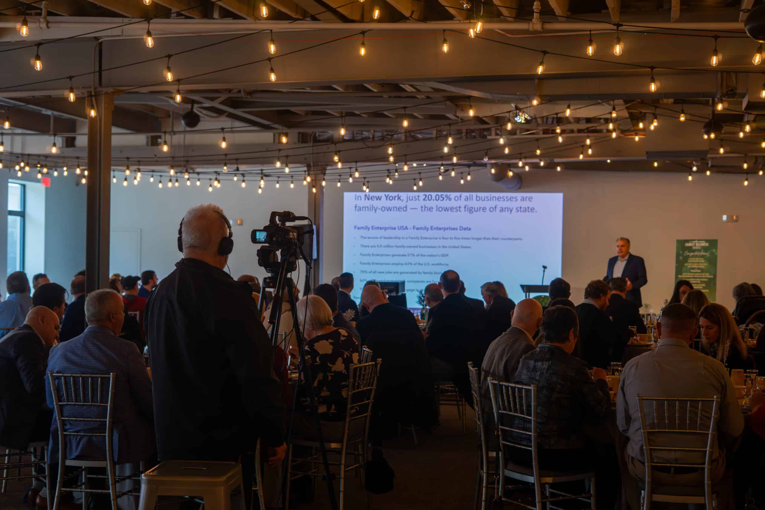 Attendees at Sky Armory conference listening to a speaker with presentation slides.