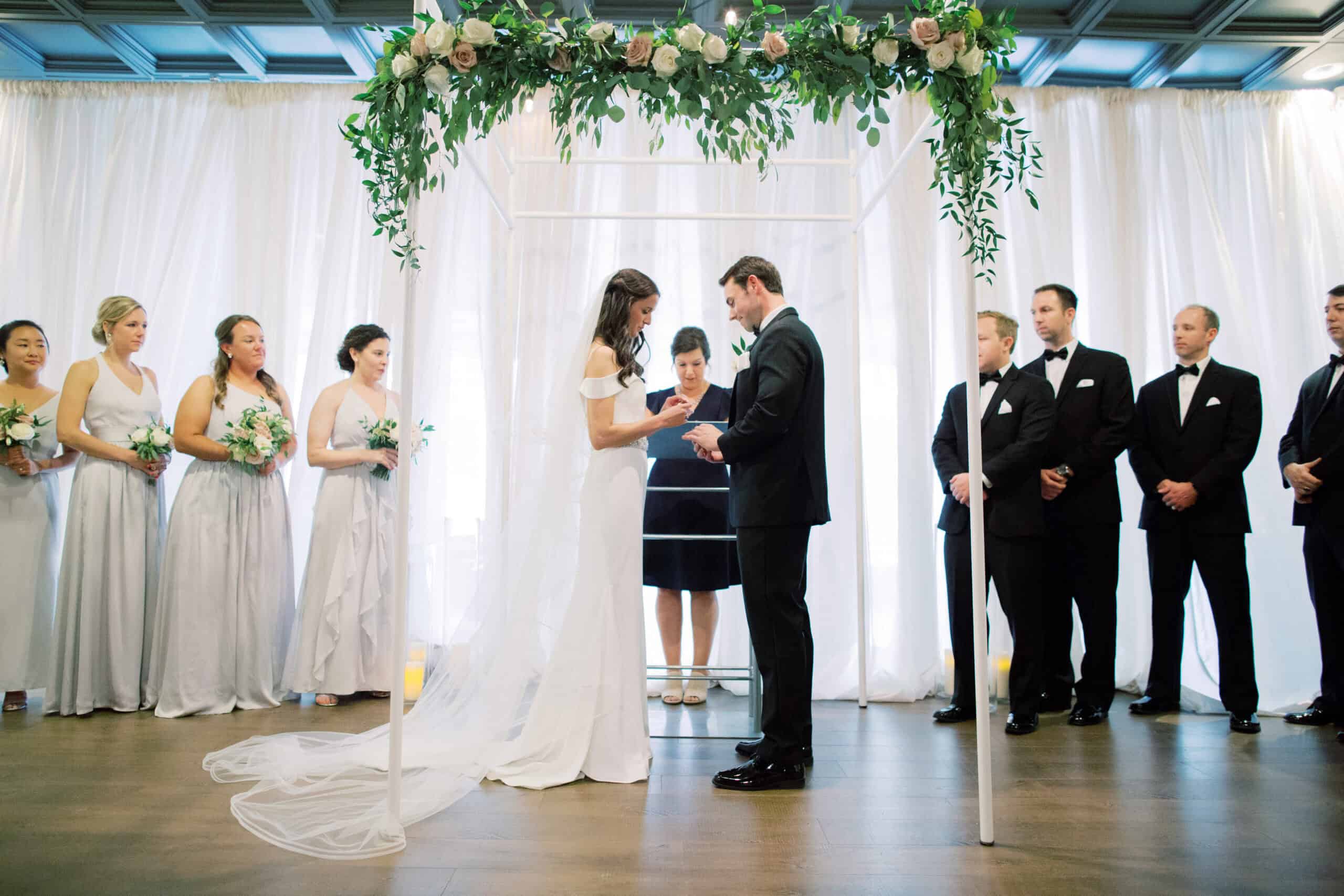 Bride and groom exchanging vows at SKY Armory wedding venue.