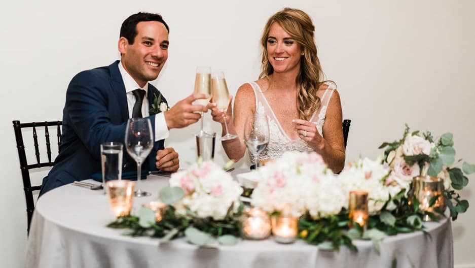 Couple celebrating with champagne toast at wedding reception.