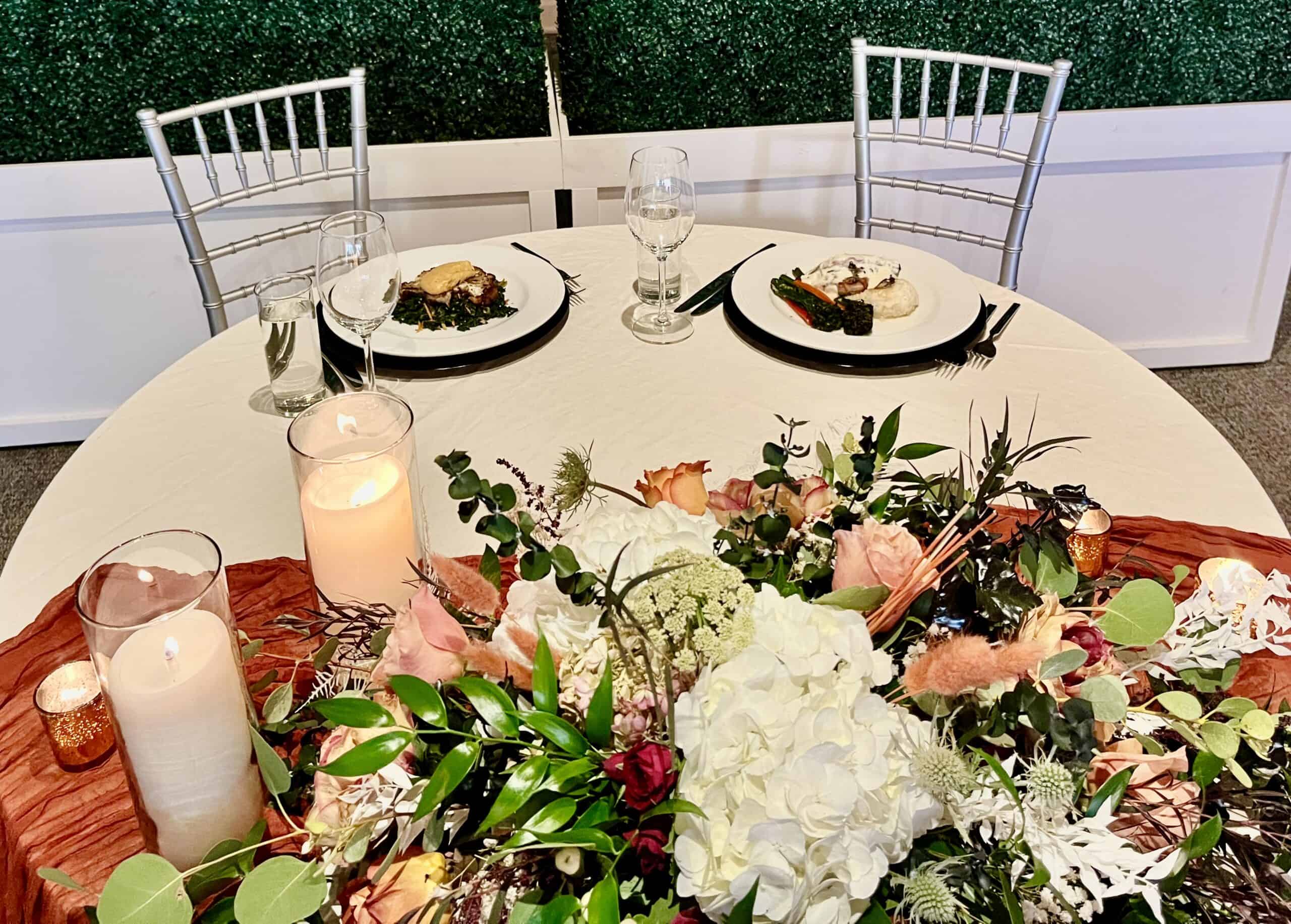 Beautiful wedding table with floral centerpiece and fine dining setup.