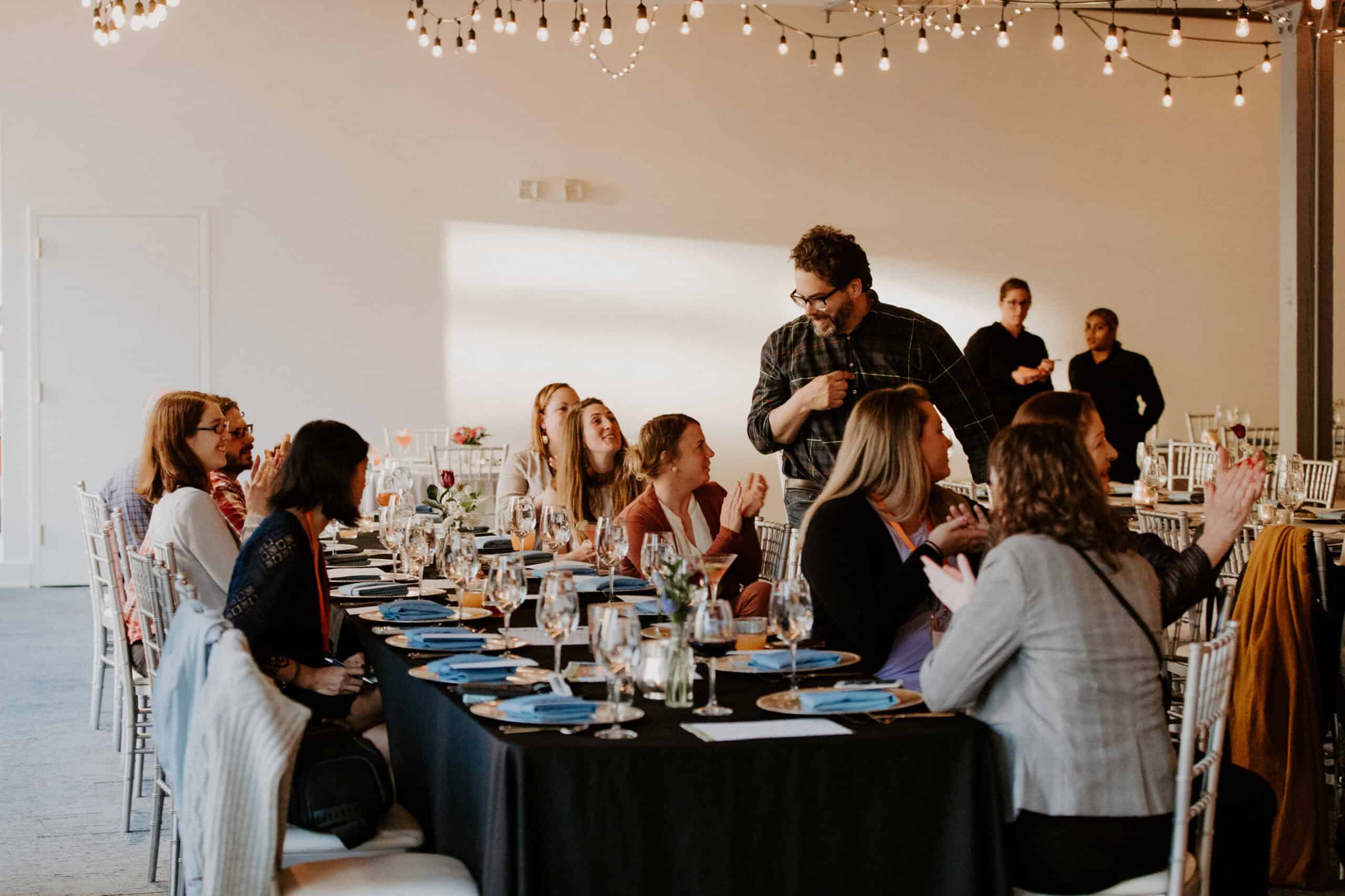 Group of people attending a formal dinner event at Sky Armory.