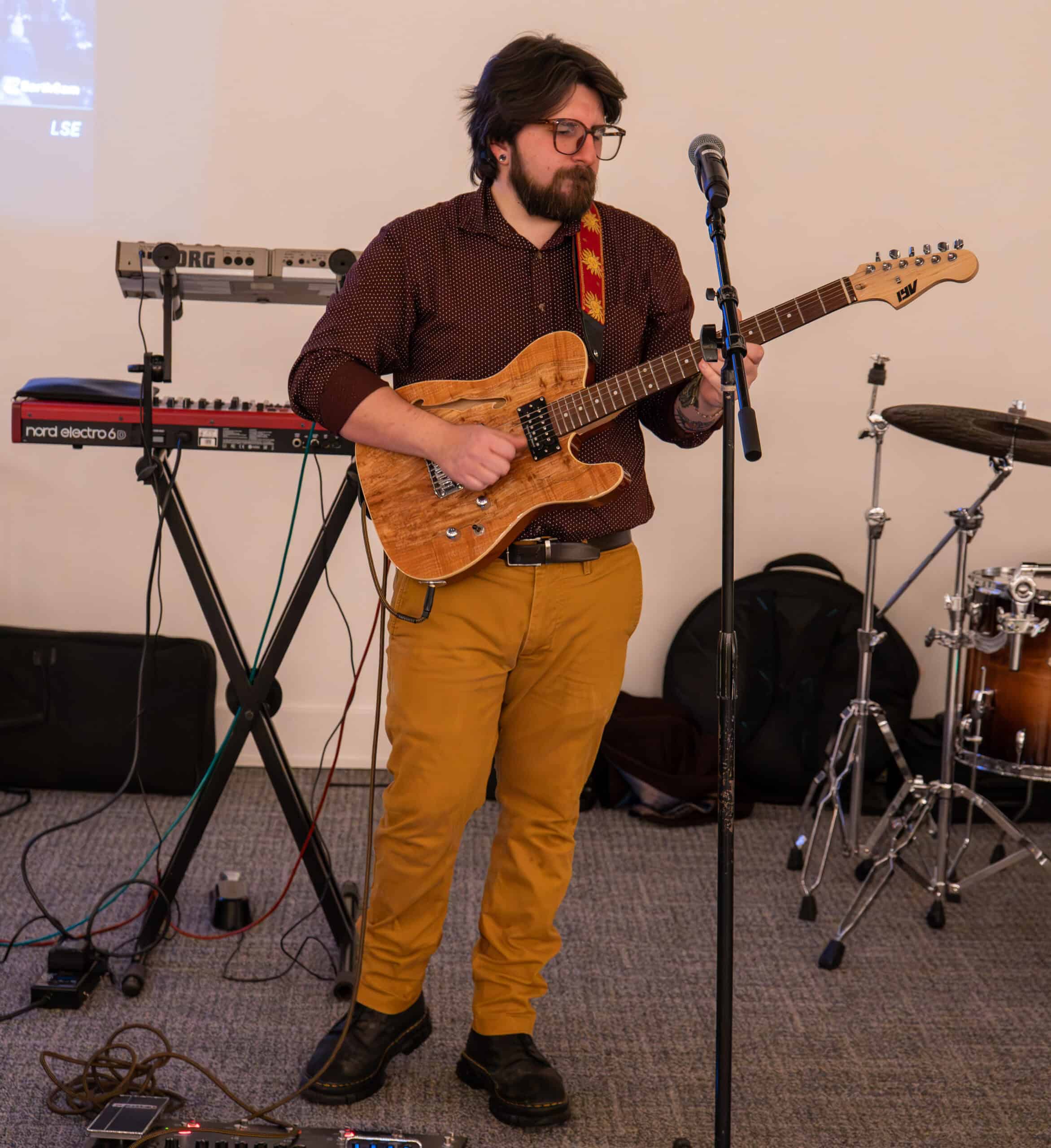 Musician playing electric guitar at SKY Armory NYE Bash event.