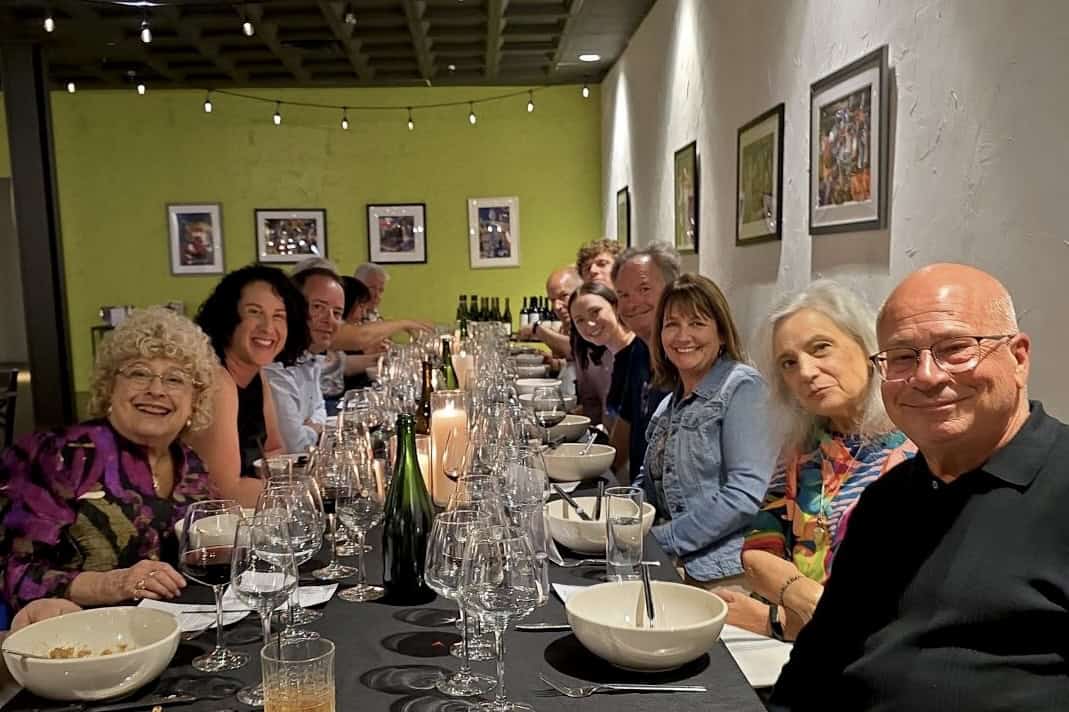 Group of people enjoying dinner at SKY Armory's tasting room.