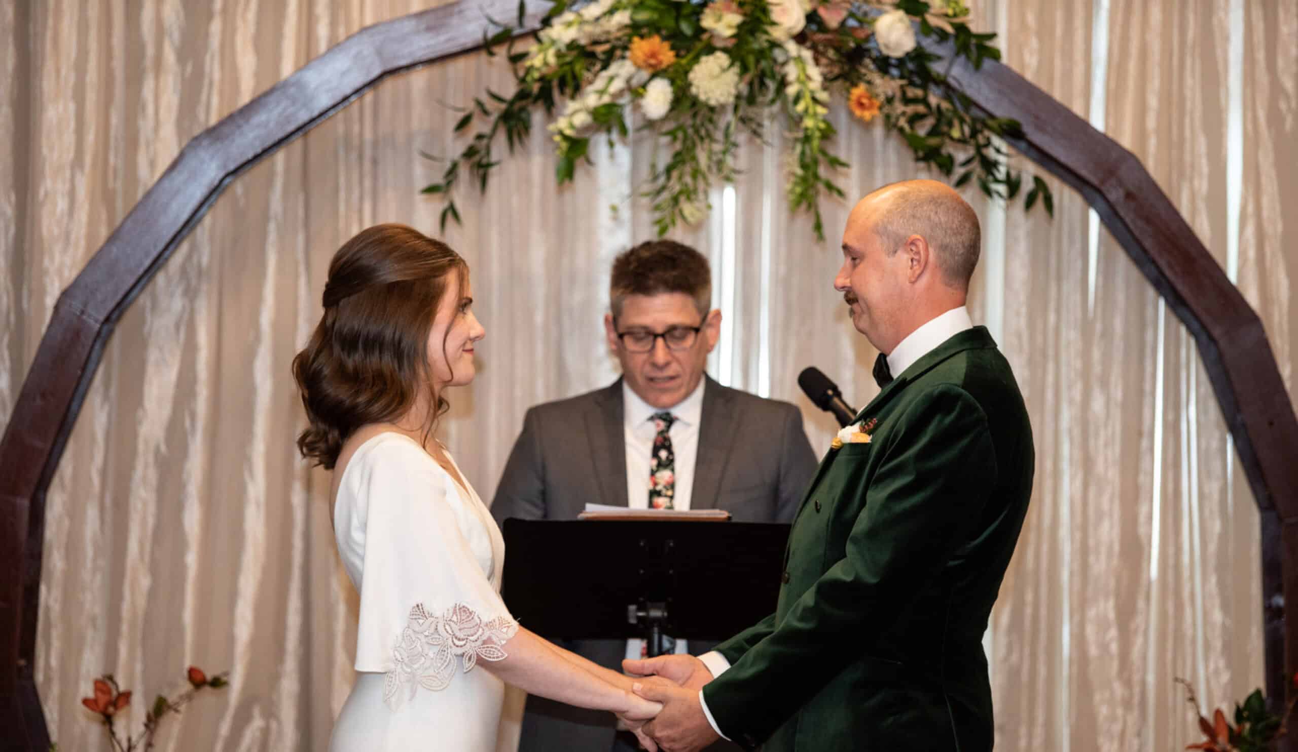 Bride and groom exchanging vows at Sky Armory wedding venue.