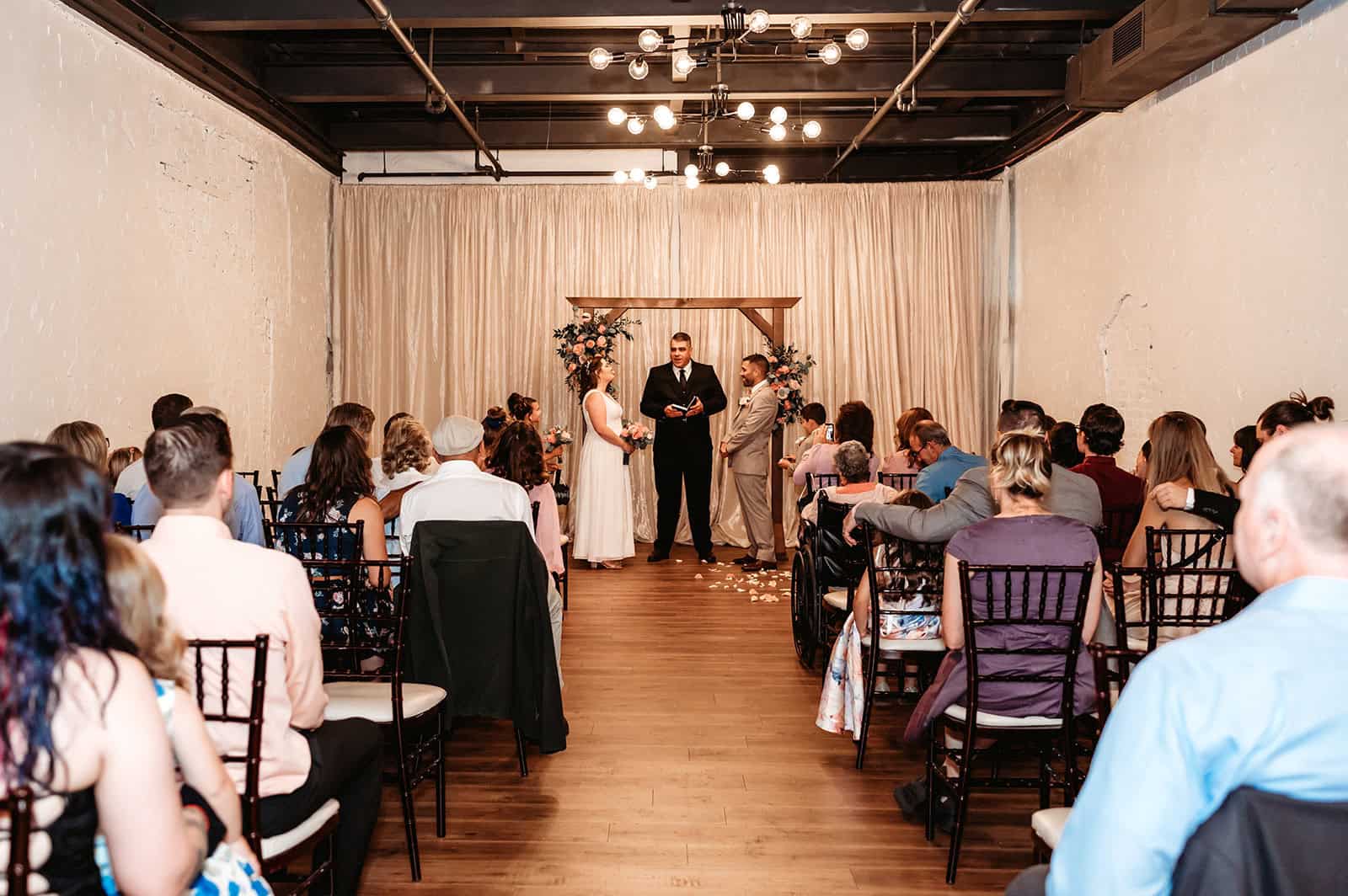 Wedding ceremony with couple and guests at SKY Armory venue.