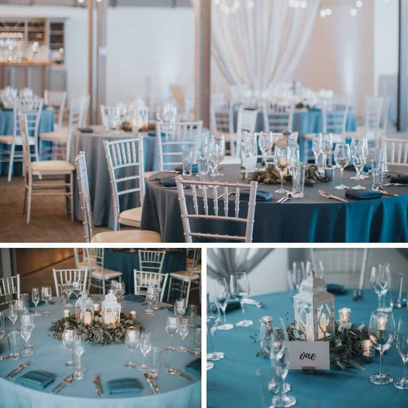 Beautifully decorated event tables with blue tablecloths and elegant glassware at SKY Armory.