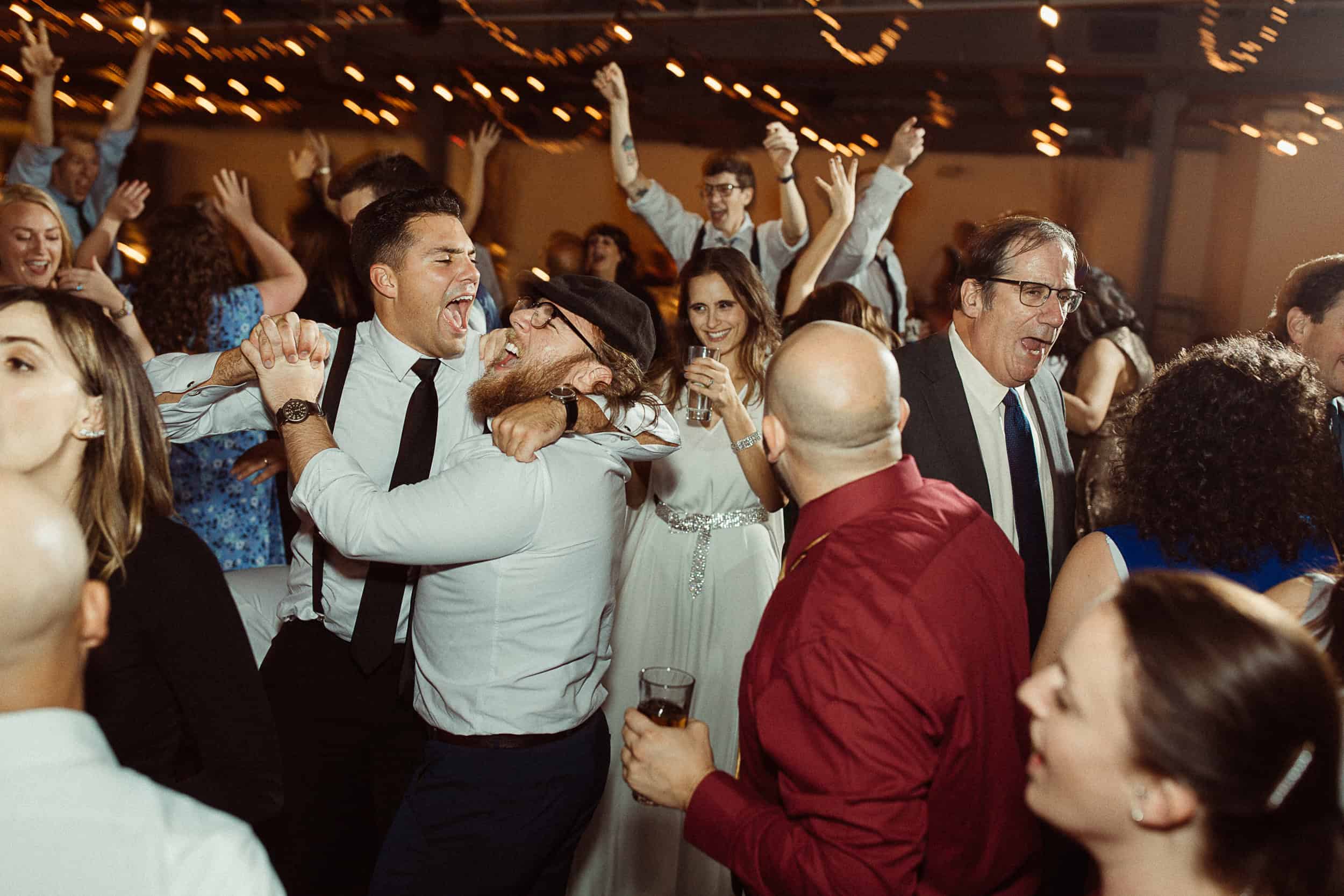 People dancing and celebrating at SKY Armory event in New York City.