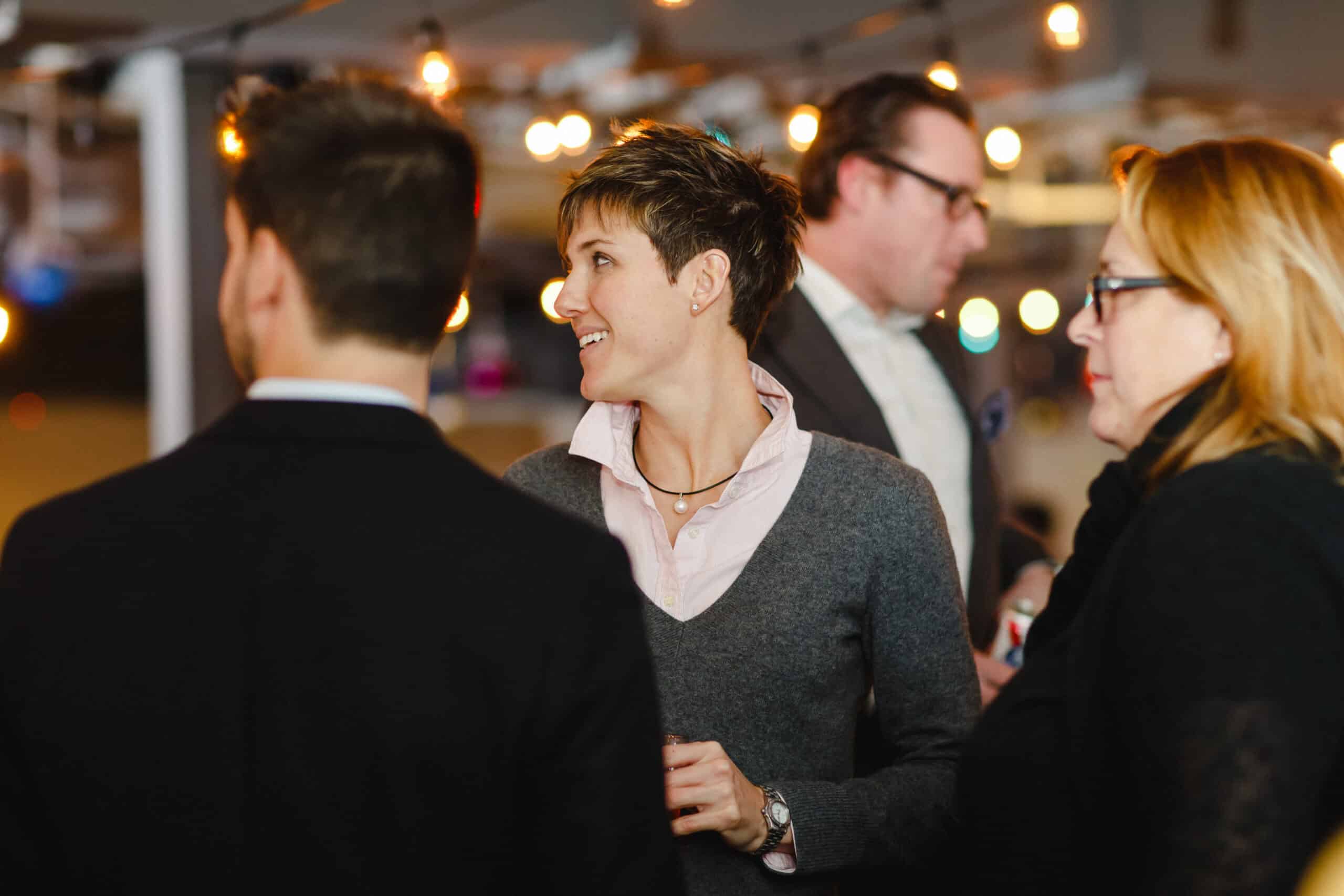 Business professionals networking at a corporate holiday party.