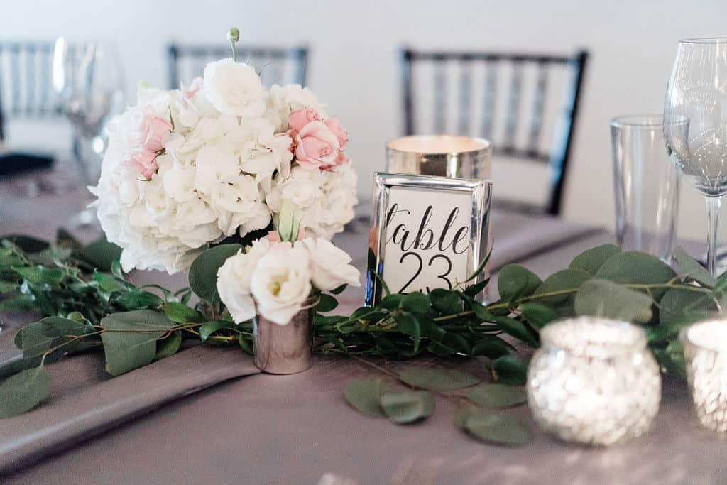 Beautiful floral centerpiece with candles for wedding reception.