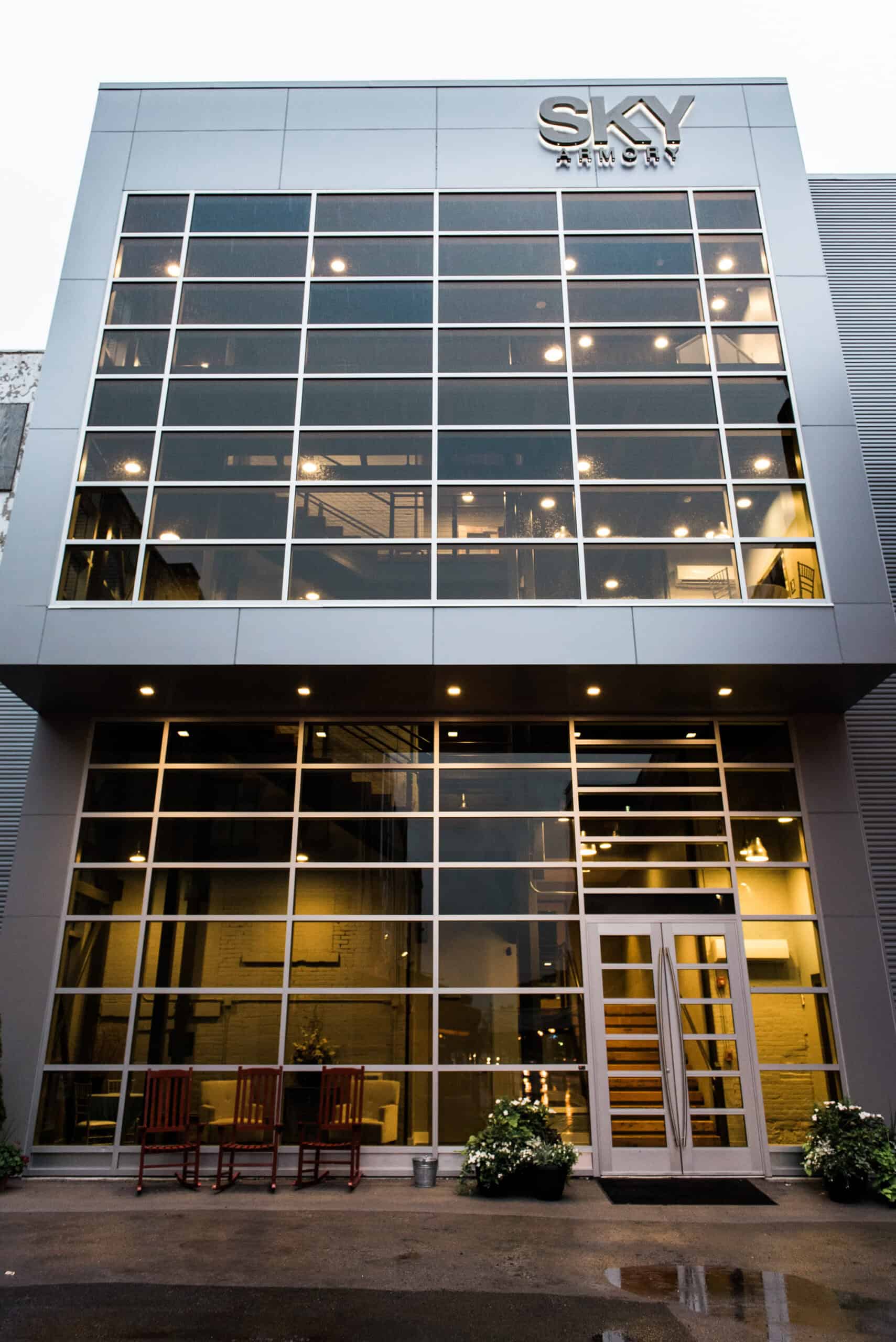 Contemporary SKY Armory building with glass facade and inviting entrance.