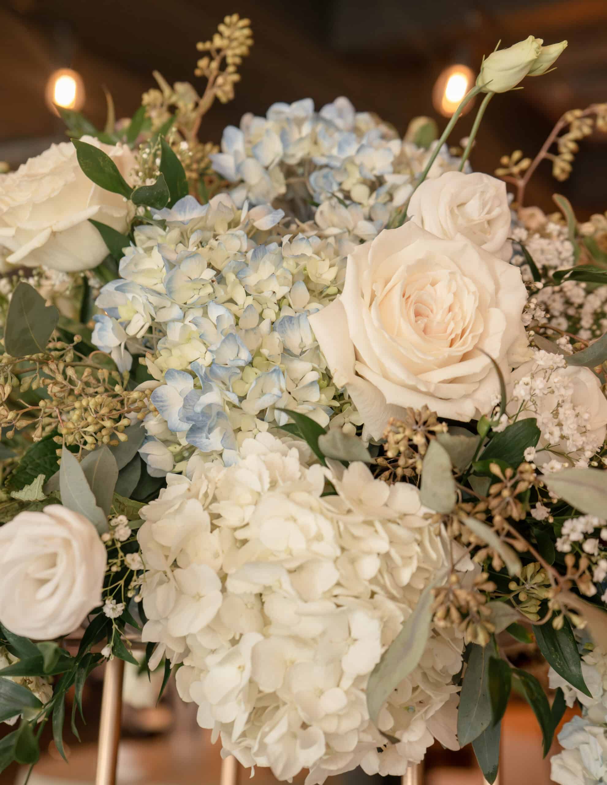 Beautiful white and light blue floral centerpiece for wedding decor.