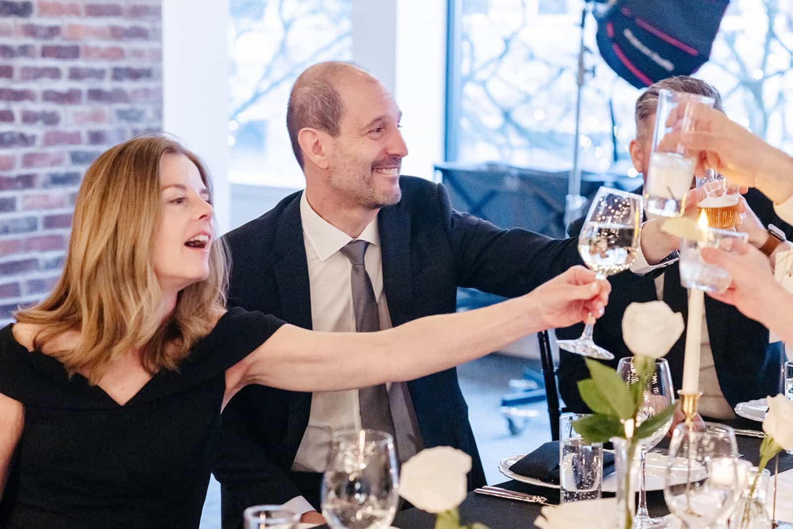 People raising glasses in toast at Sky Armory event.