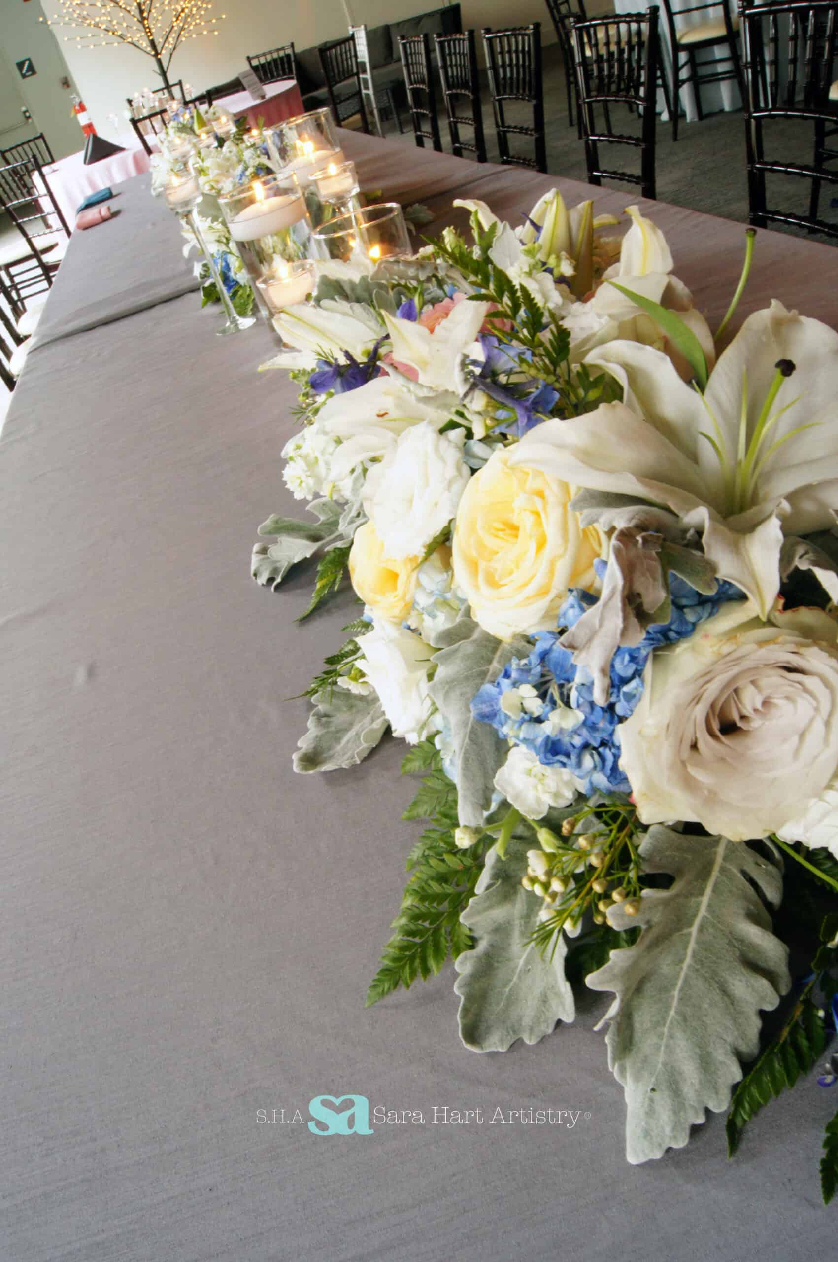 Beautiful floral centerpiece with roses and lilies for wedding decor.