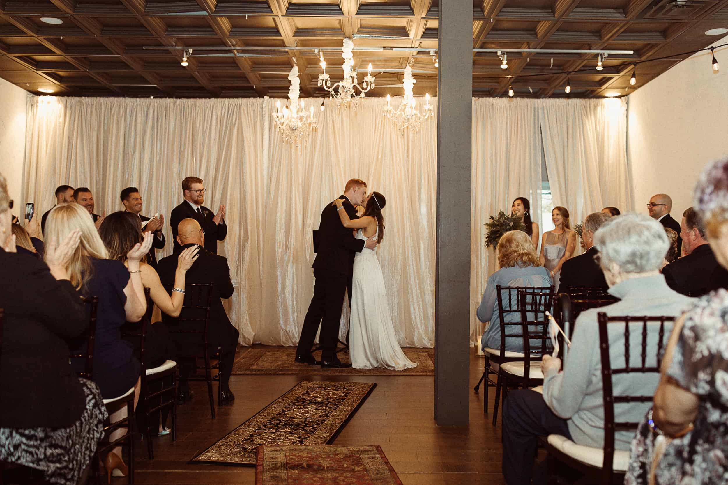 Couple's first dance during wedding at SKY Armory with guests watching.