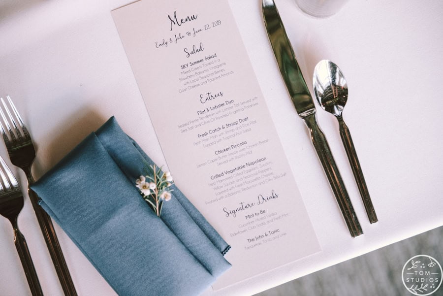 Sky Armory menu with silverware and blue napkin for fine dining.