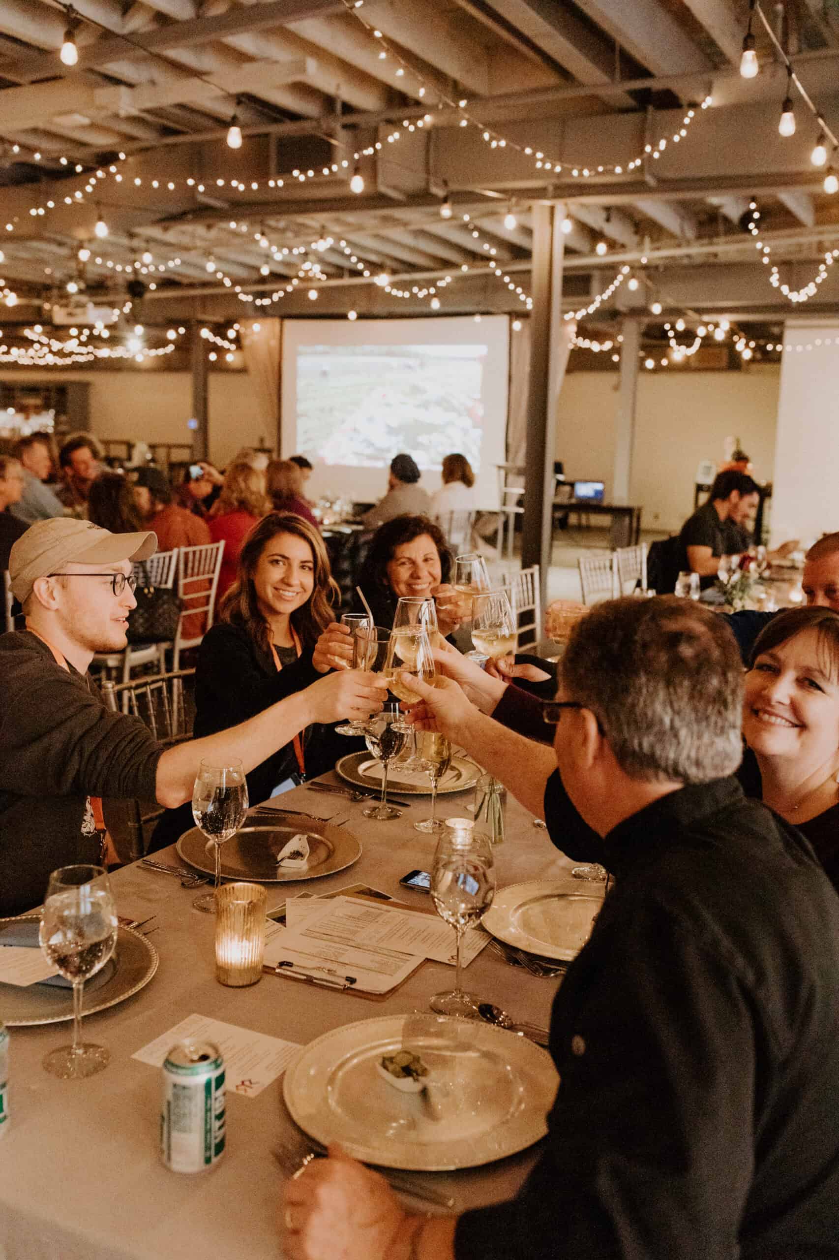 Group of people celebrating with drinks at Sky Armory event.