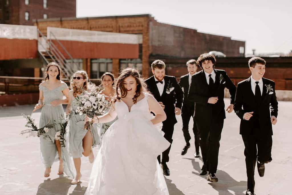 Wedding party walking outdoors in stylish attire at SKY Armory.