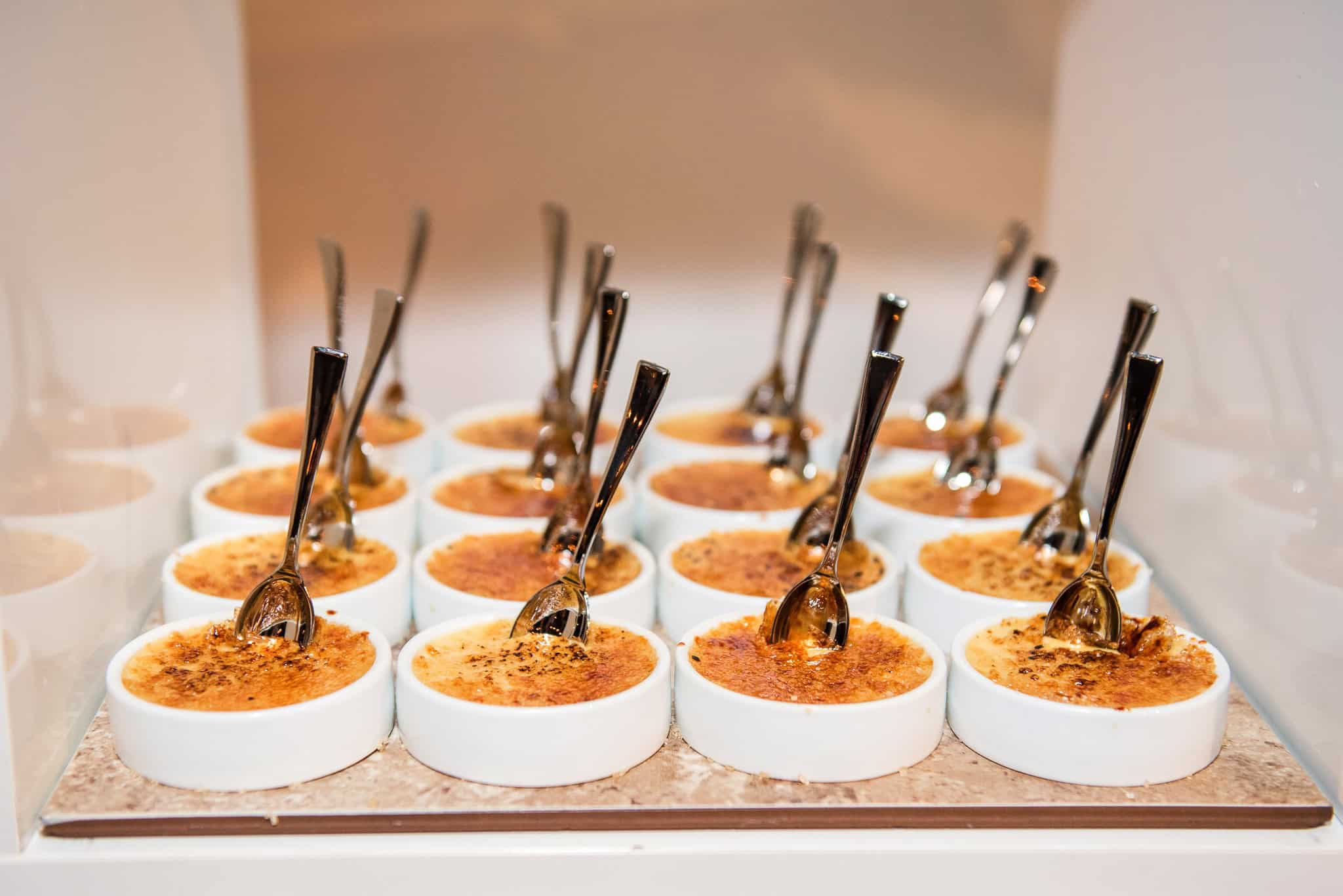 Elegant winter wedding appetizers served in small white bowls with spoons.