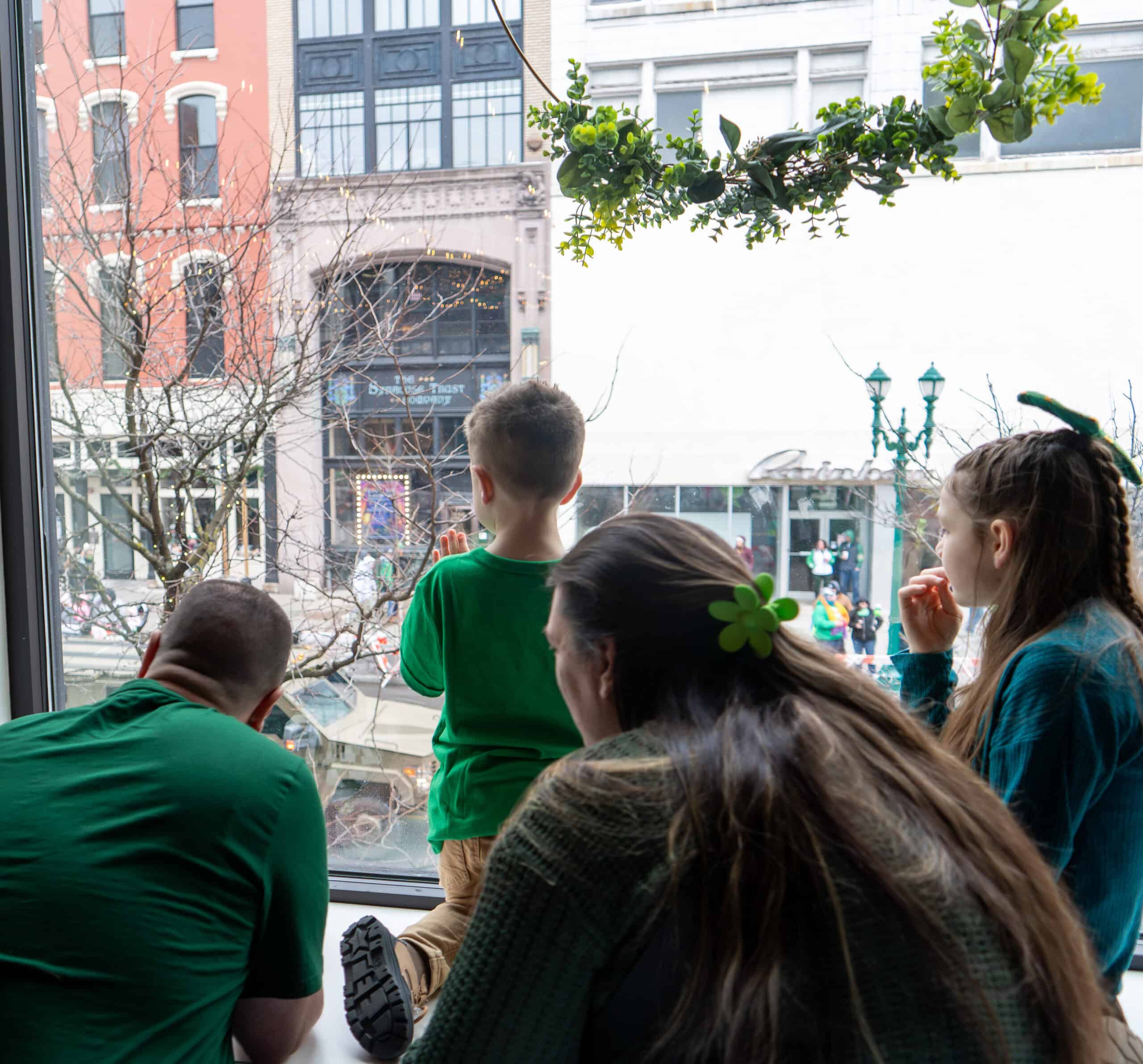 Children observing city street from SKY Armory window in New York City.