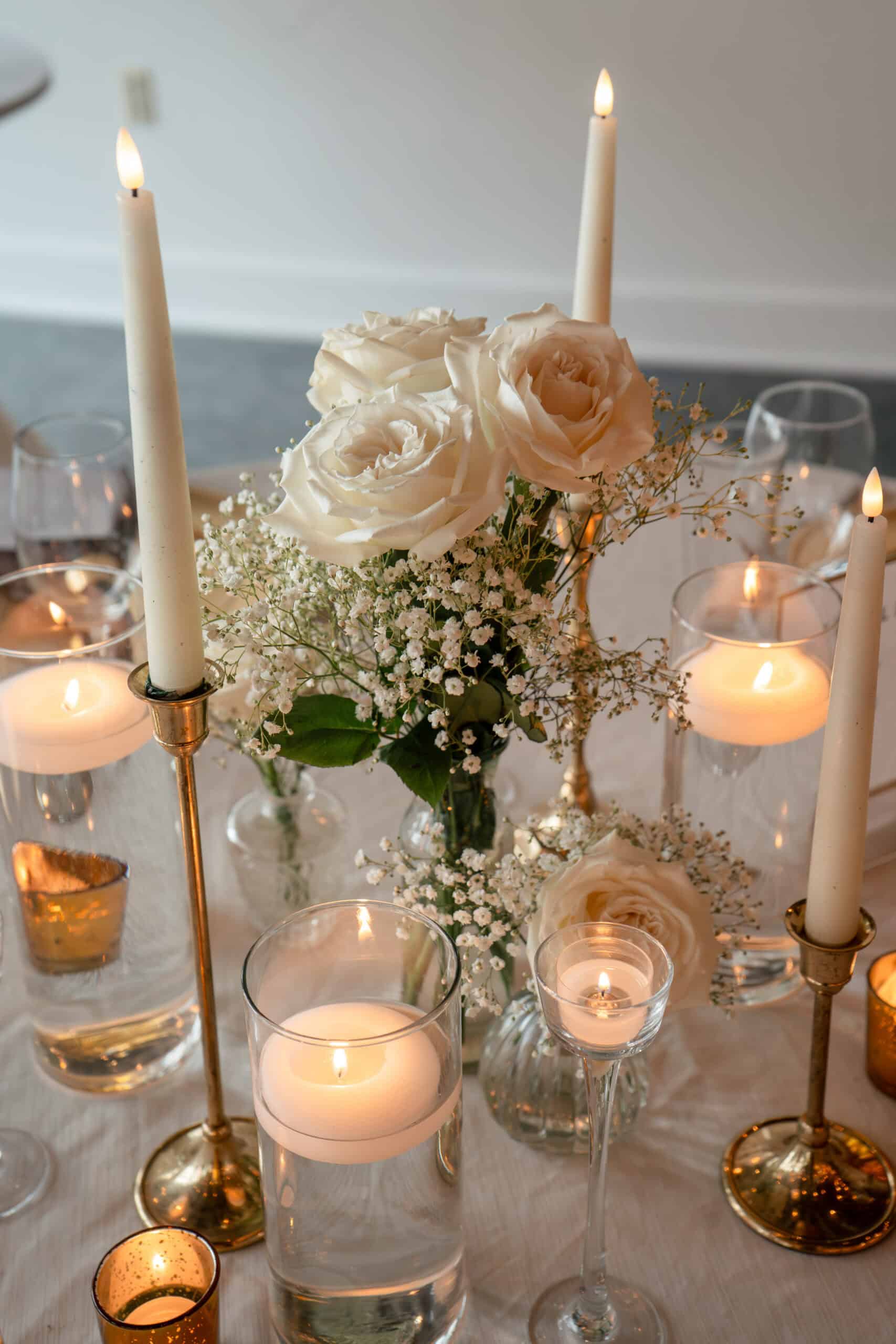 Beautiful floral arrangement with candles for wedding or special event decor.