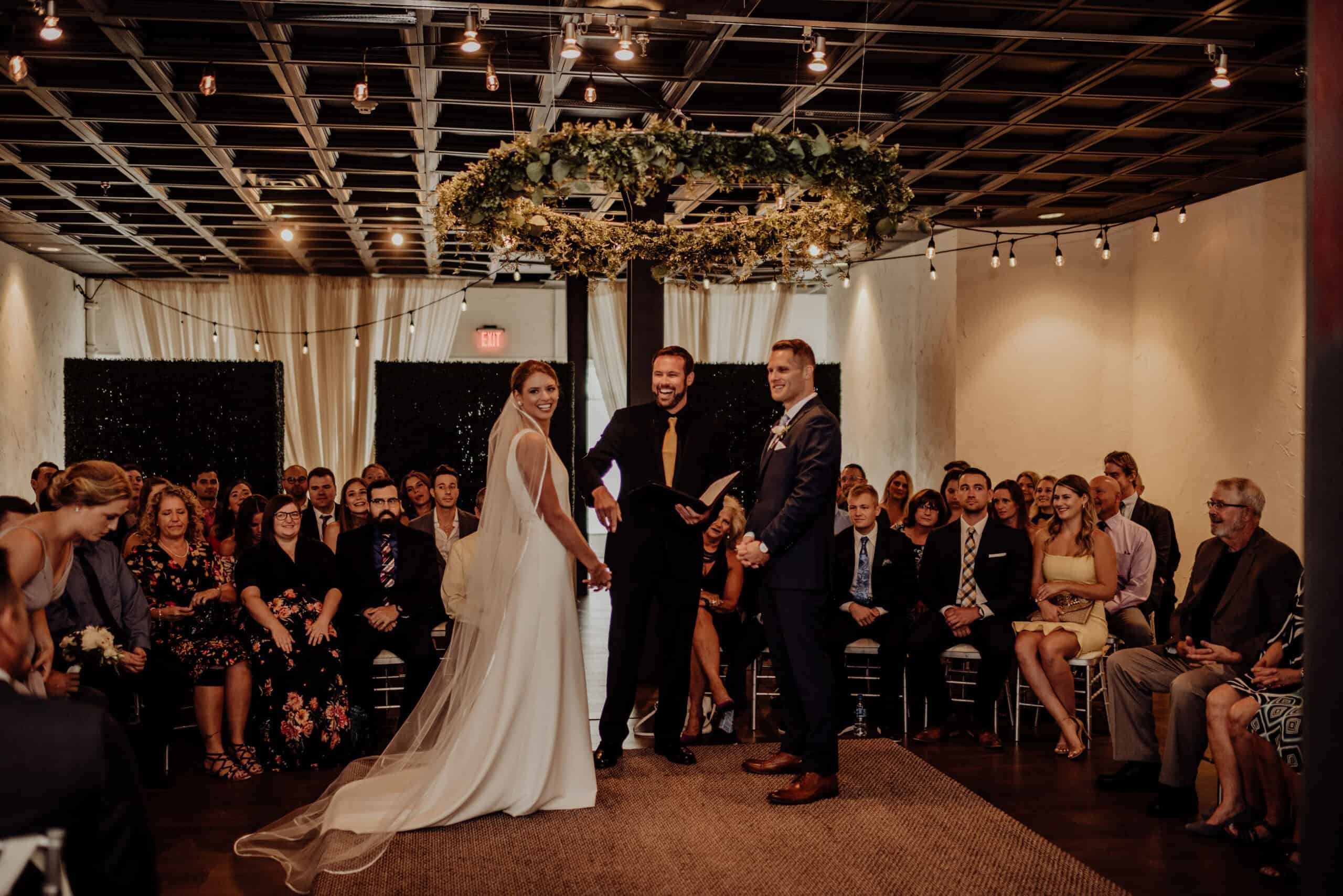 Bride and groom exchanging vows at SKY Armory wedding venue.