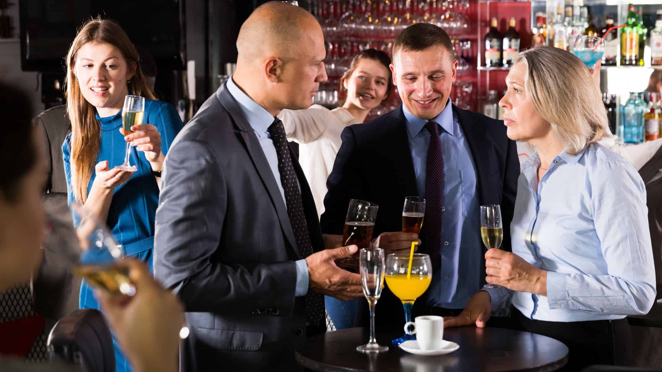 Business professionals enjoying drinks at a corporate event.