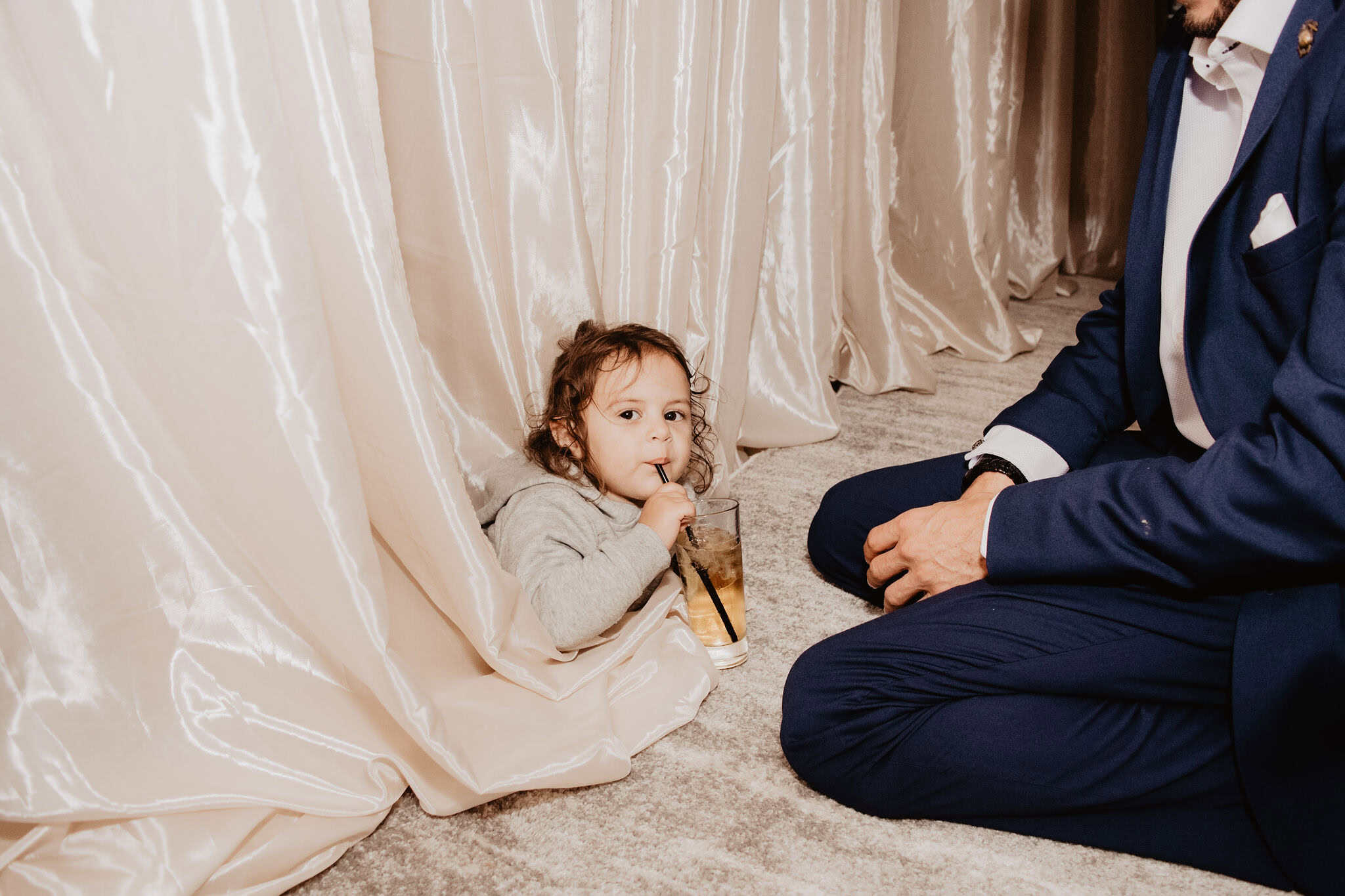 Young girl and man in formal attire at cultural event.
