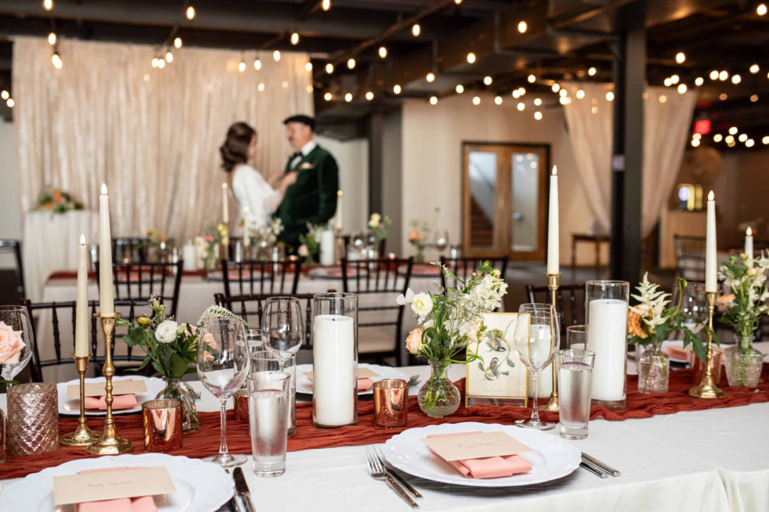 Beautiful wedding reception with floral centerpieces and candlelit decor at SKY Armory.