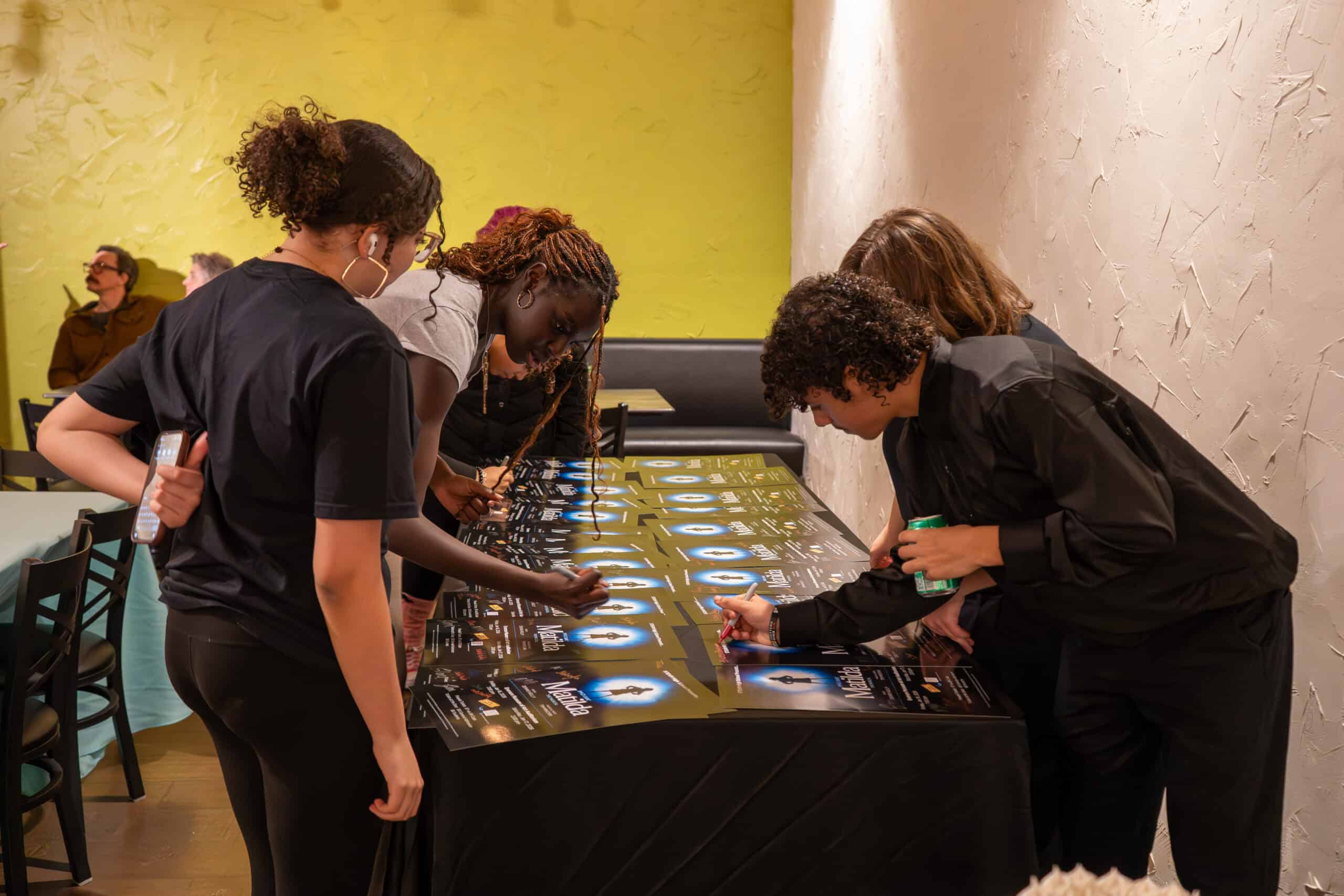Group of people playing a tabletop game at SKY Armory.
