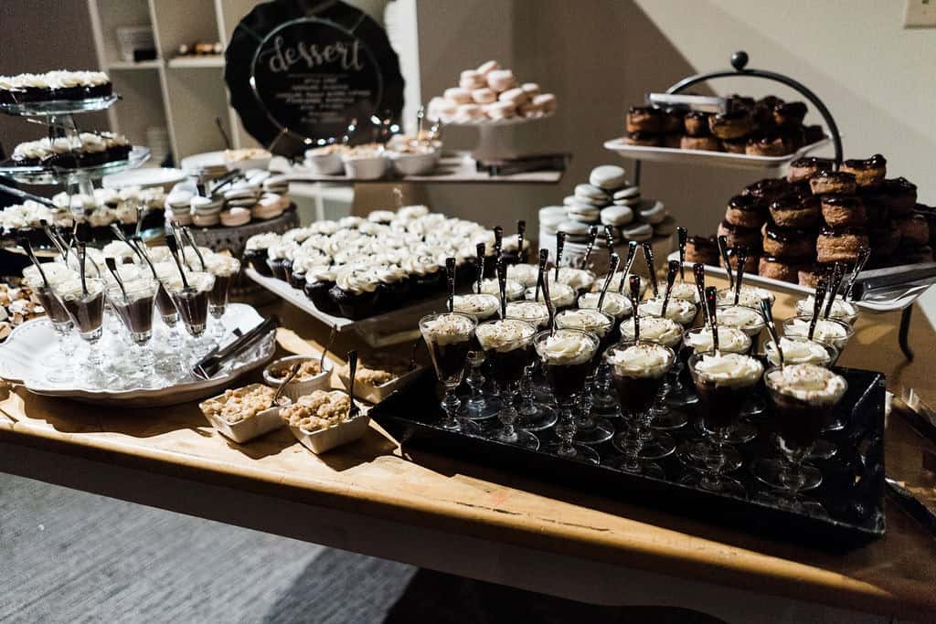 Assorted desserts and sweets on a dessert table for a celebration.