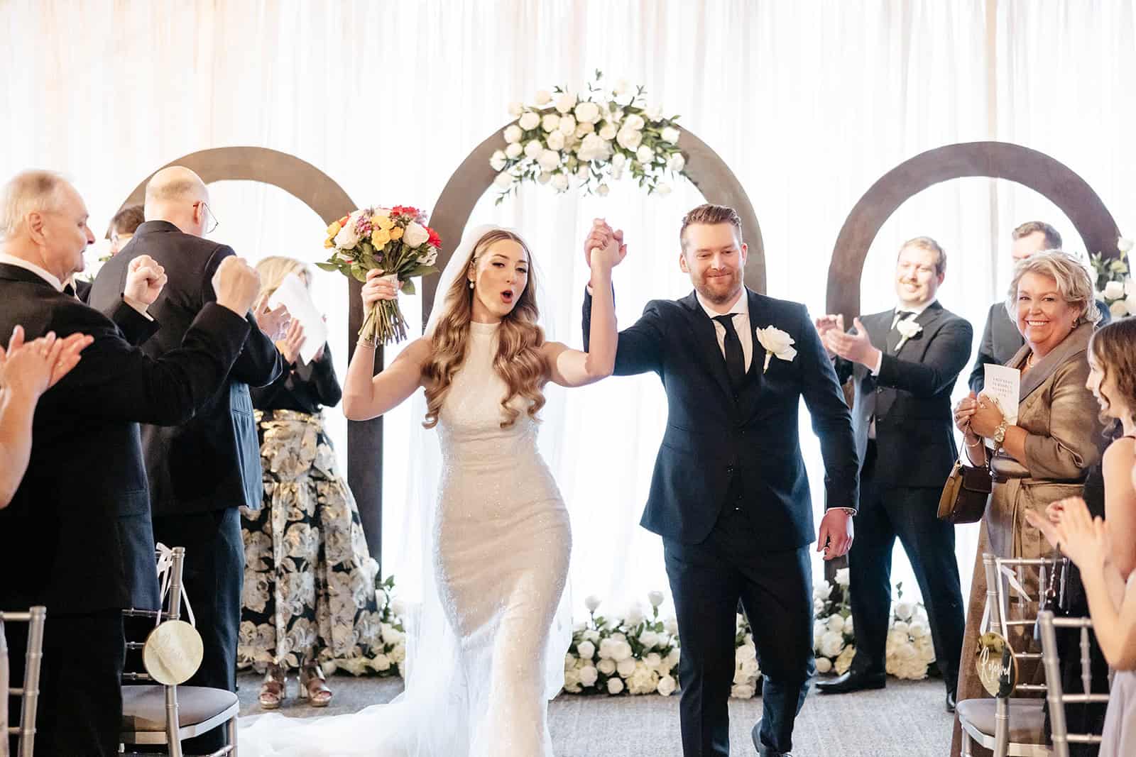 Bride and groom celebrating wedding with guests at Sky Armory venue.