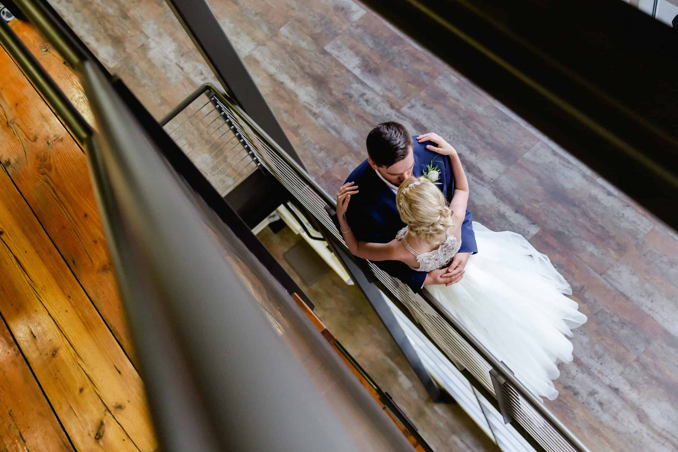Bride and groom sharing a dance on a staircase at SKY Armory.