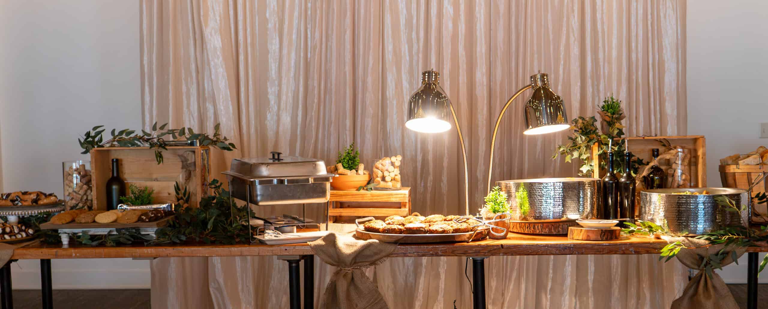 Buffet table with food and warm lighting at SKY Armory event.
