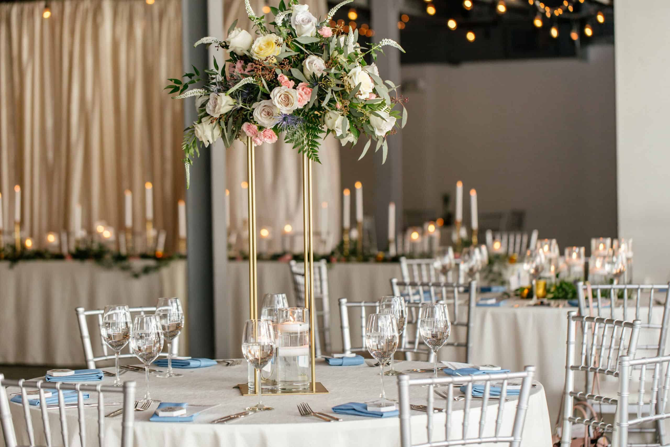 Beautiful wedding reception with floral centerpiece and candlelit tables.