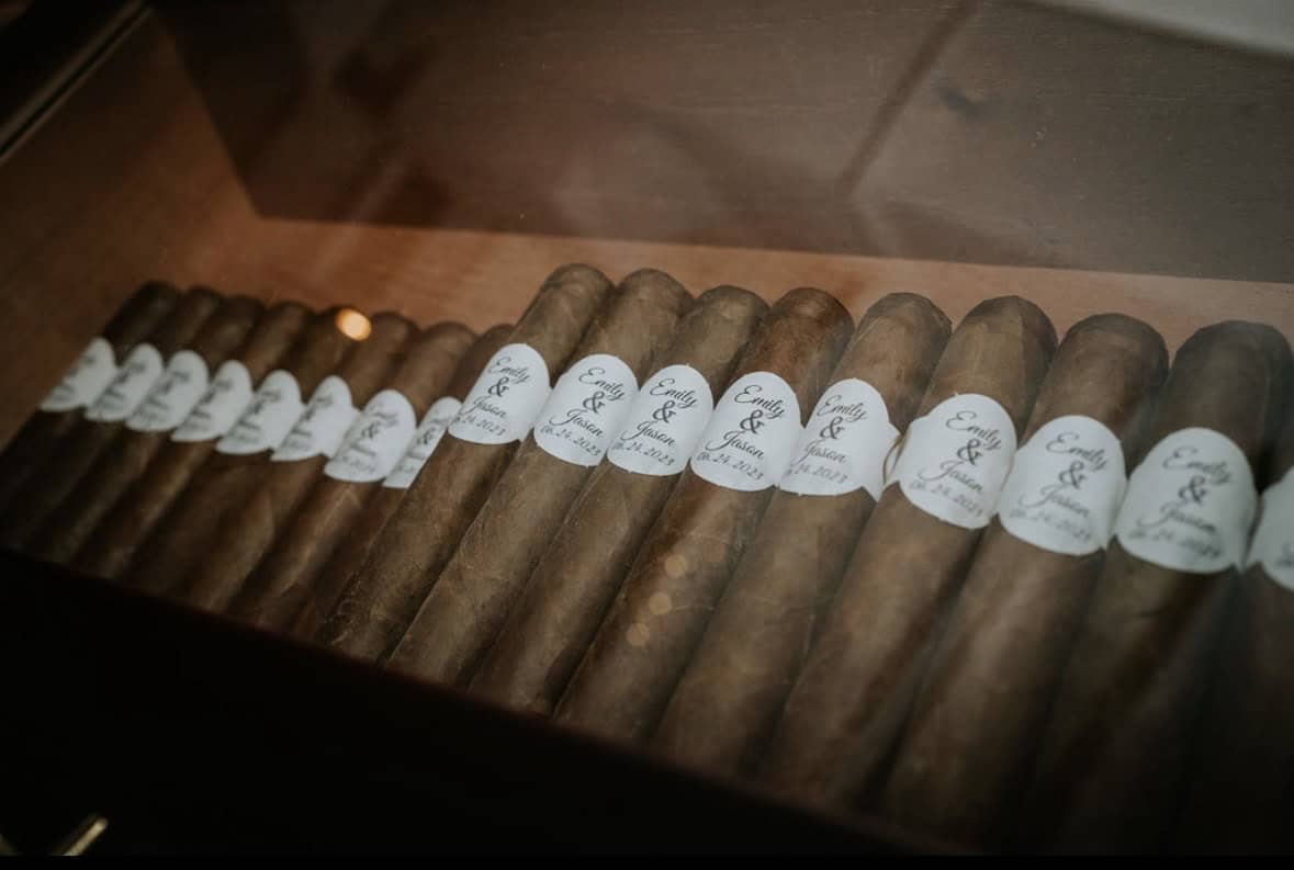Close-up of premium cigars with SKY Armory labels in display case.