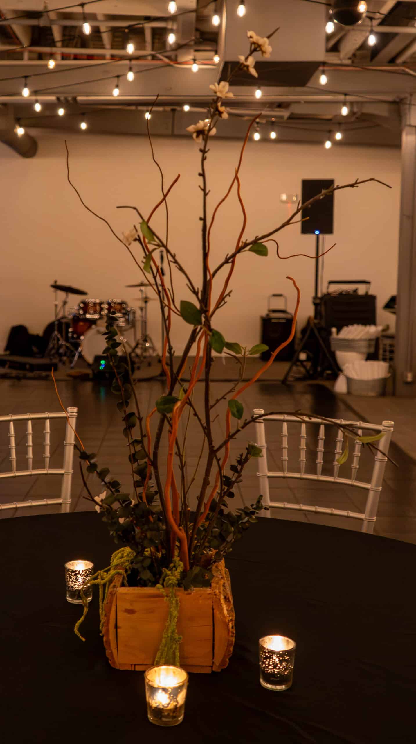 Decorative floral centerpiece with candles at SKY Armory NYE event.